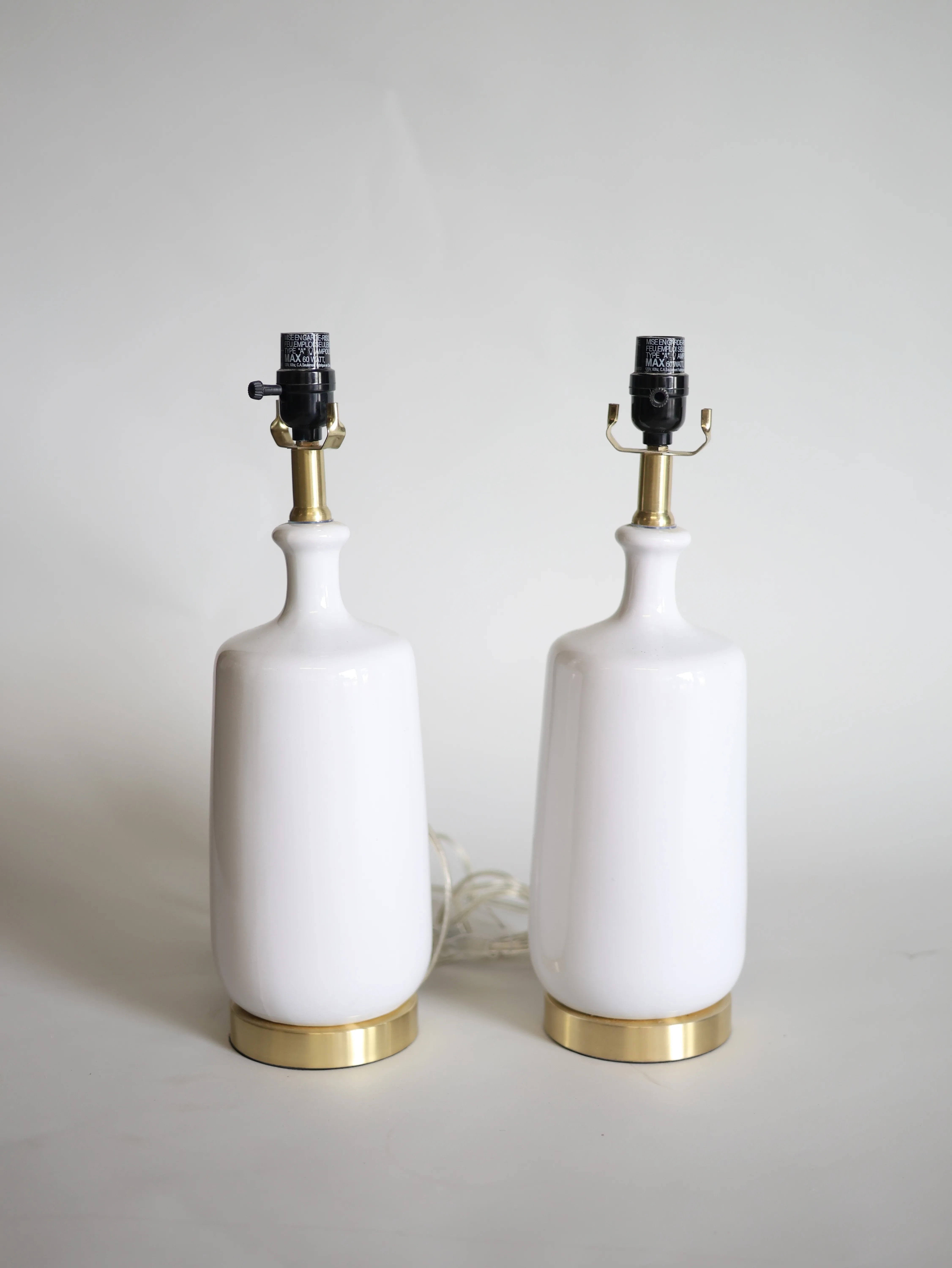 Pair of white table lamp bases with golden base