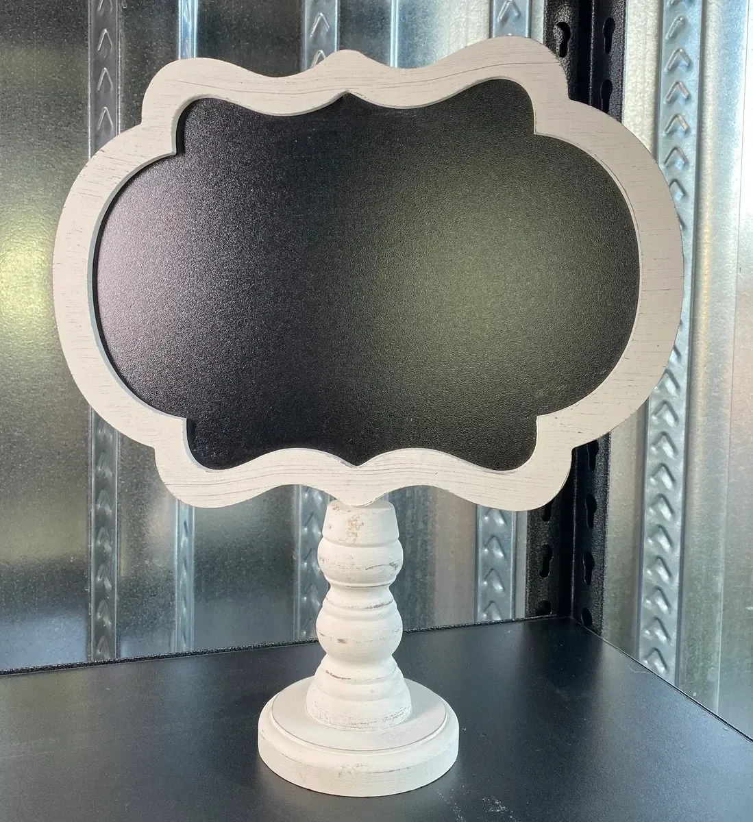 Scalloped white wood chalkboard sign on pedastal