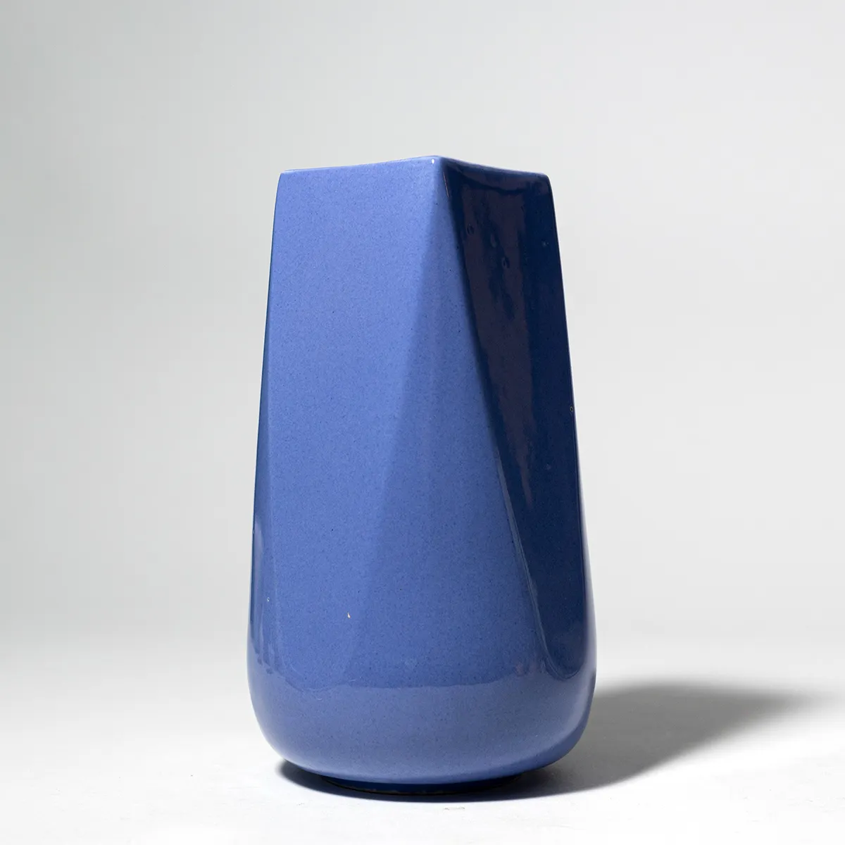 Tall Periwinkle Ceramic Vase Round at the Bottom and Square at the top straight sides lead to the square opening