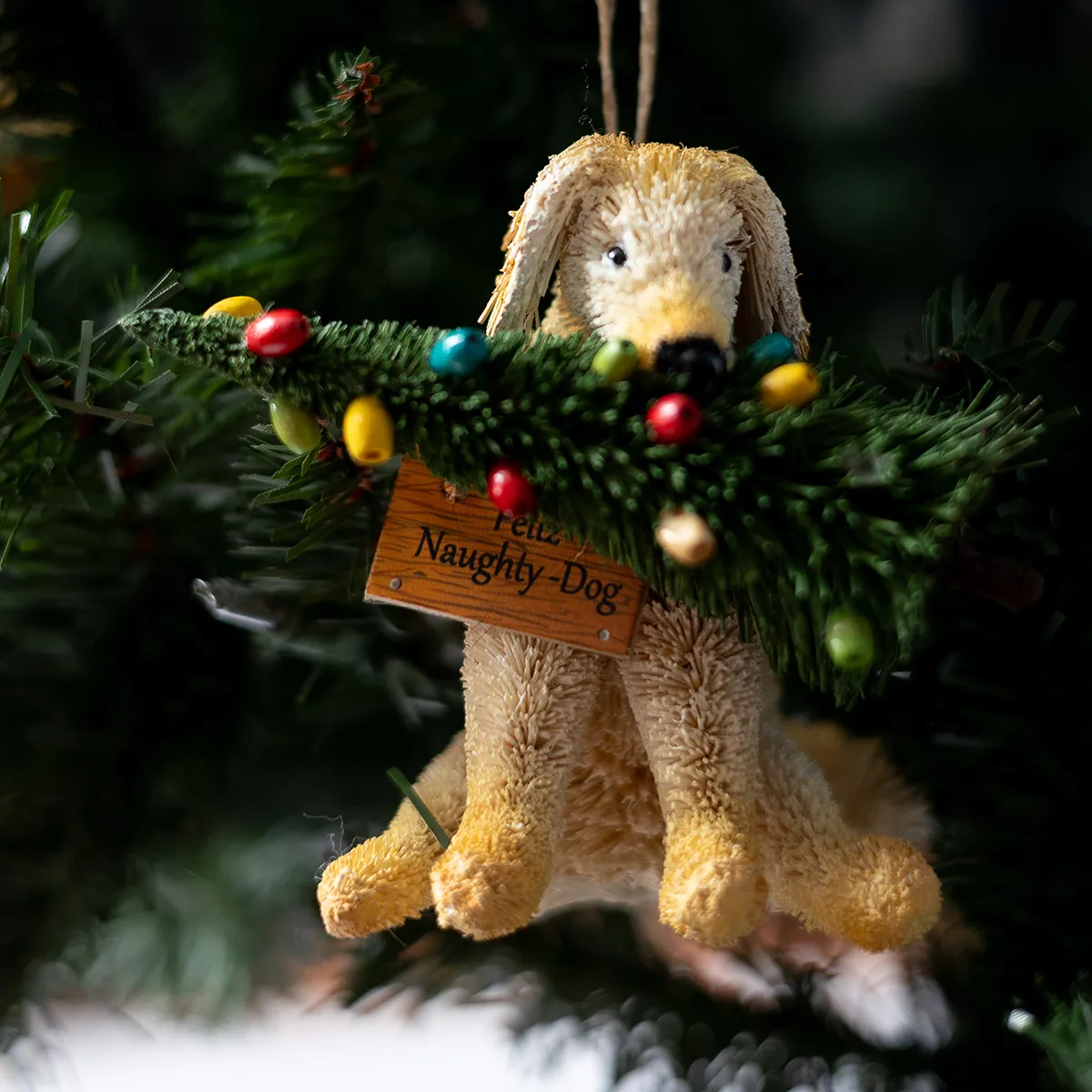 Feliz Naughty Dog, Golden Retriever Christmas Ornament with Decorated Christmas tree in its mouth - Pottery Barn Bottle Brush Hanging ornament