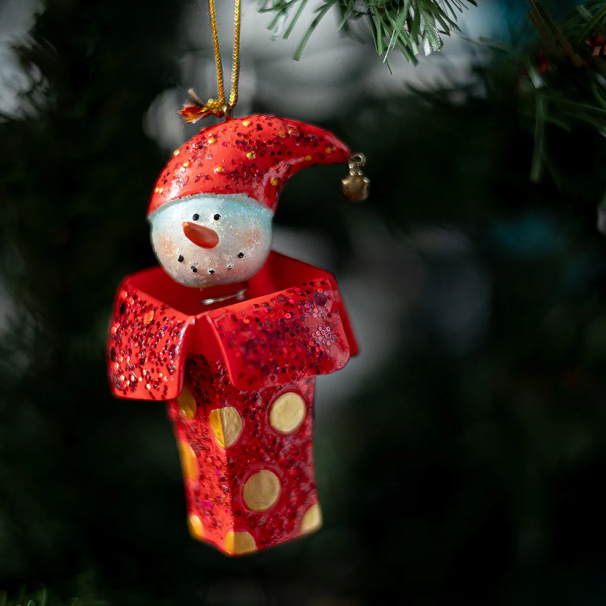 Snowman head with red sock cap on a spring. Jack in the box Christmas Tree Ornament. 
