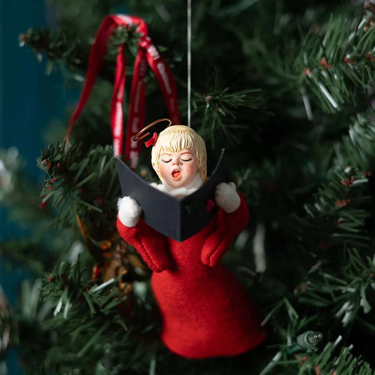 Choir Singer Figurine in a red dress holding a song book
