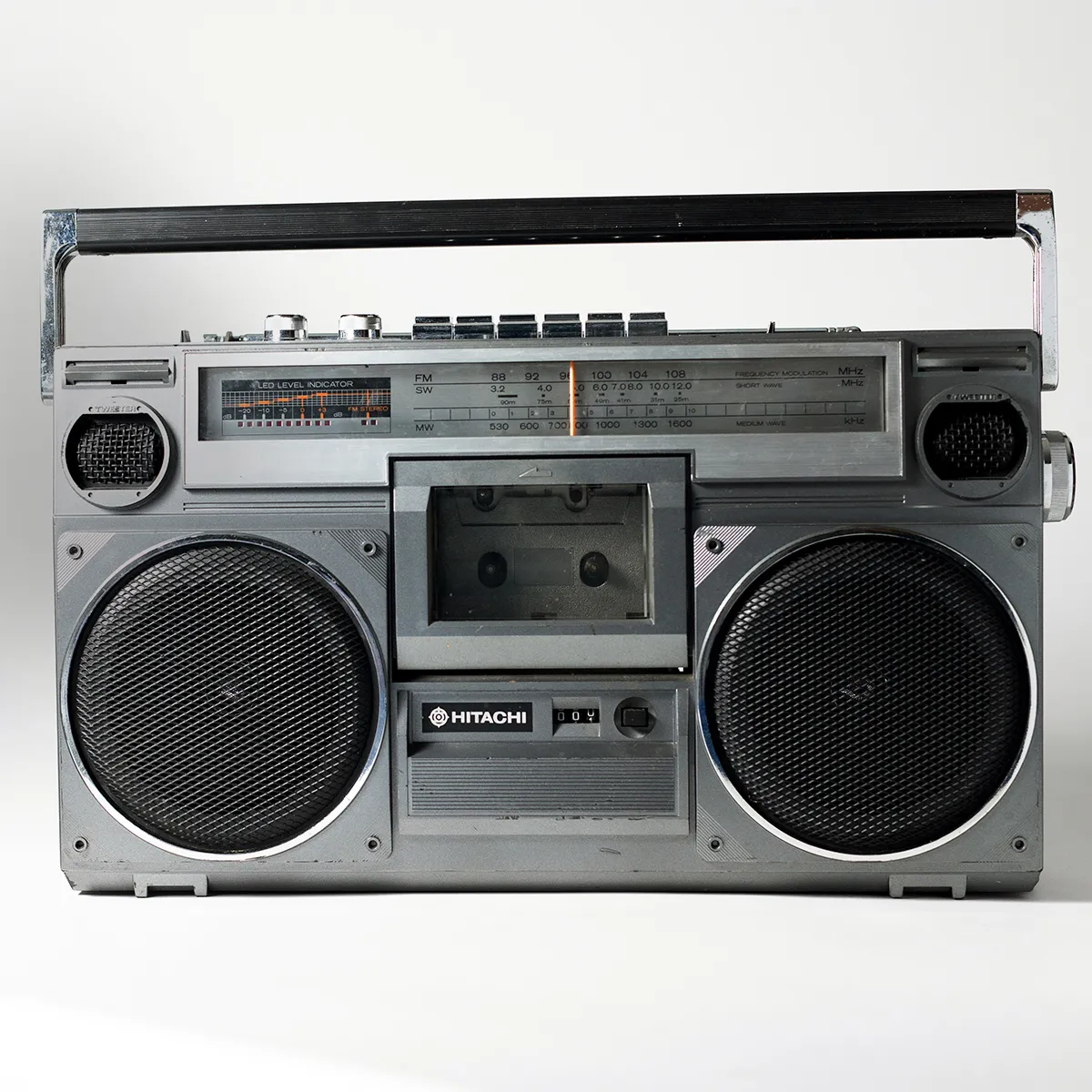80s Boom Box. Vintage Hitachi Portable Stereo Radio Cassette. Silver with Black Speaker Mesh 