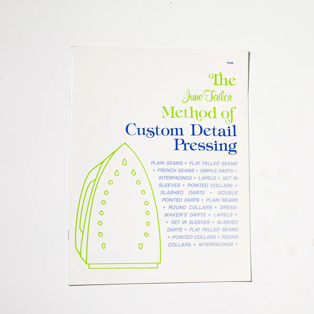 Book Pamphlet: Custom Detail Pressing Cream with a Green One Line Drawing of an Iron