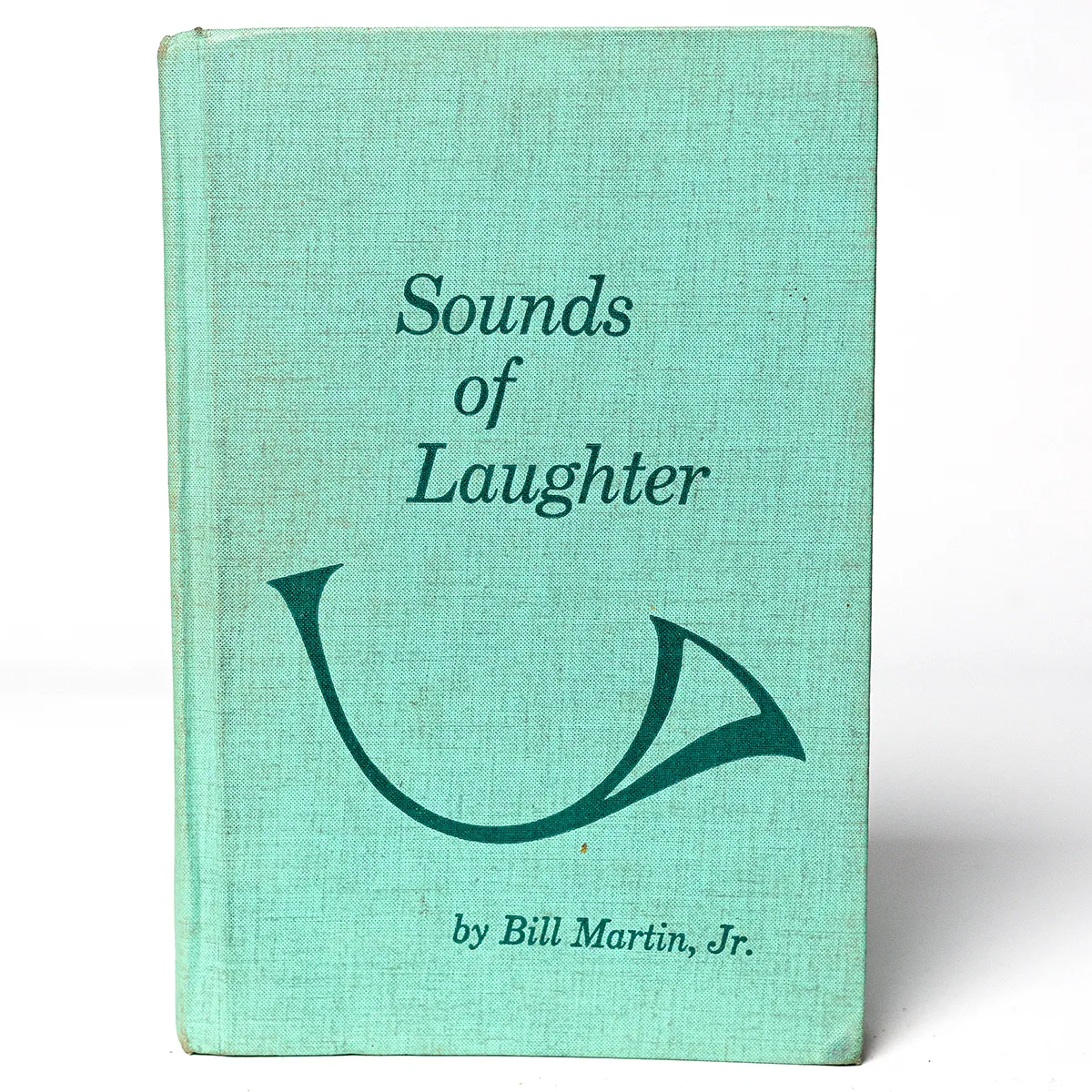 Hardcover Book "Sounds of Laughter" Teal with a bugle on the cover