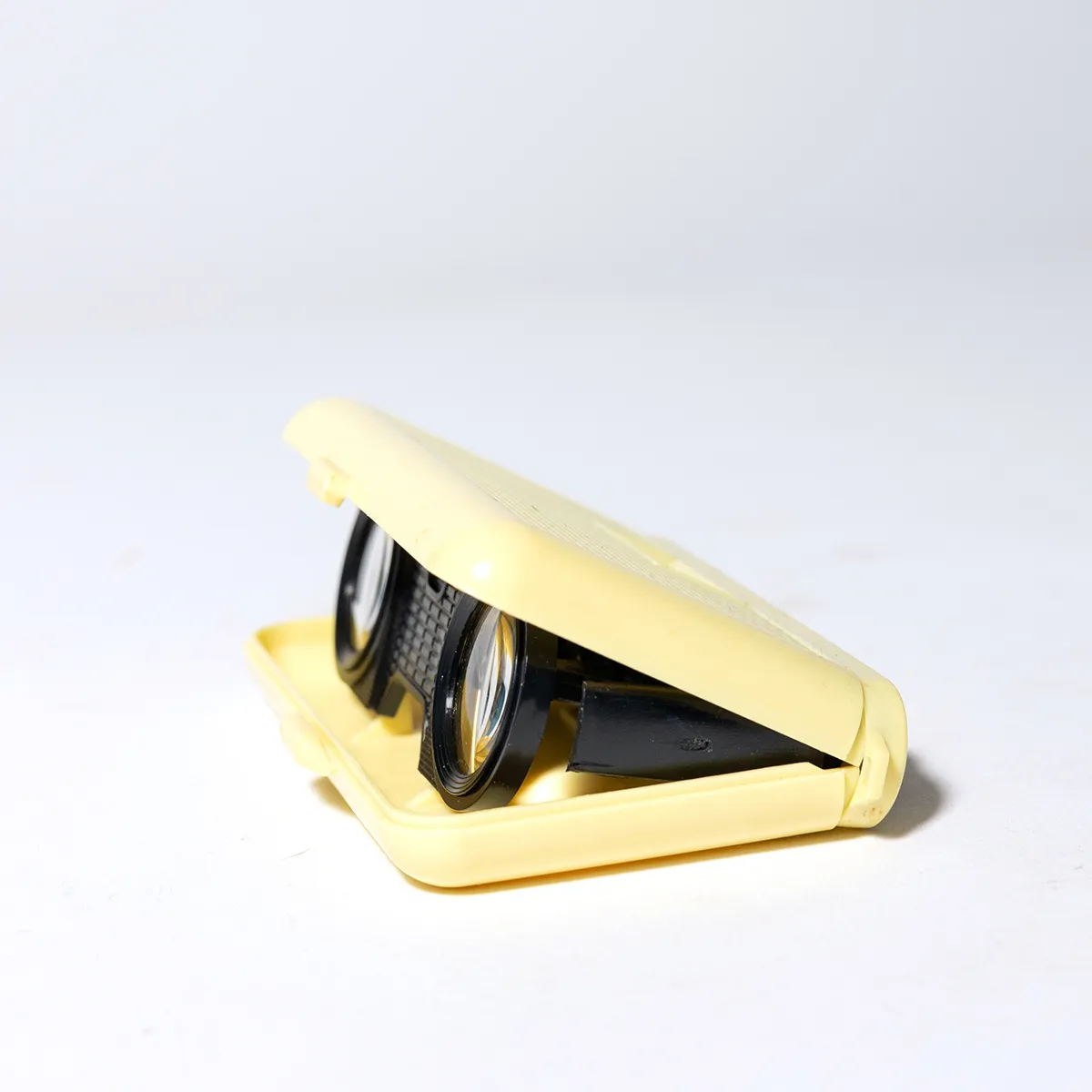 Collapsible Pocket Binoculars. 1950 Textured Cream Yellow Plastic Cover and Black Glasses Inside.