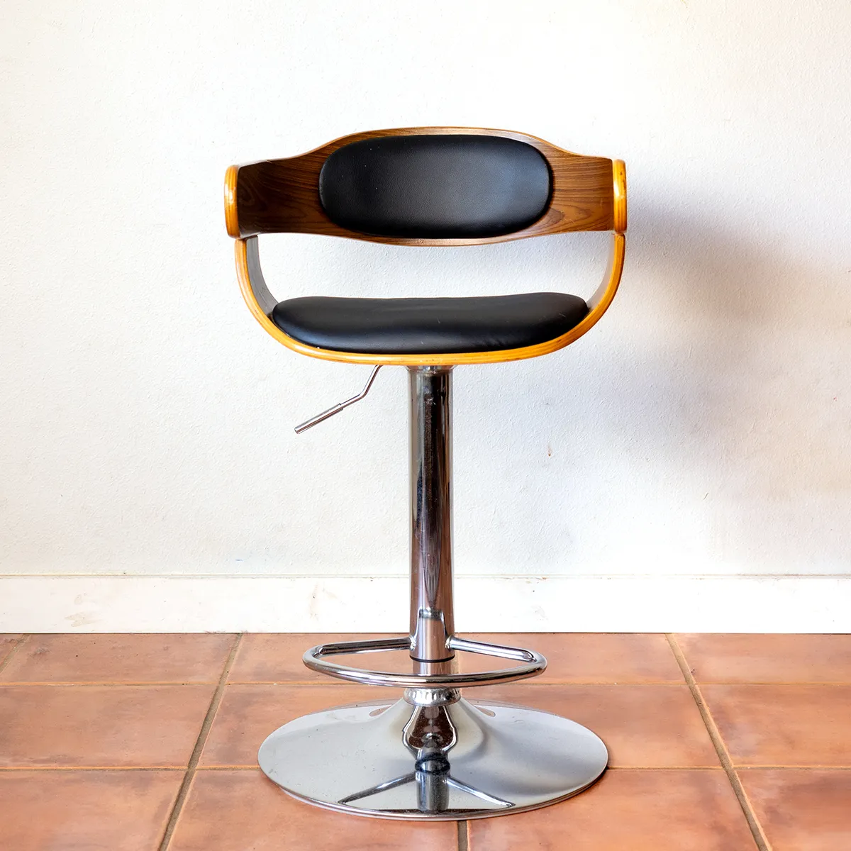 Retro Mid-Century Modern Stool with Chrome base. Medium Grain Wood with Black Leather cushioned seat and back rest