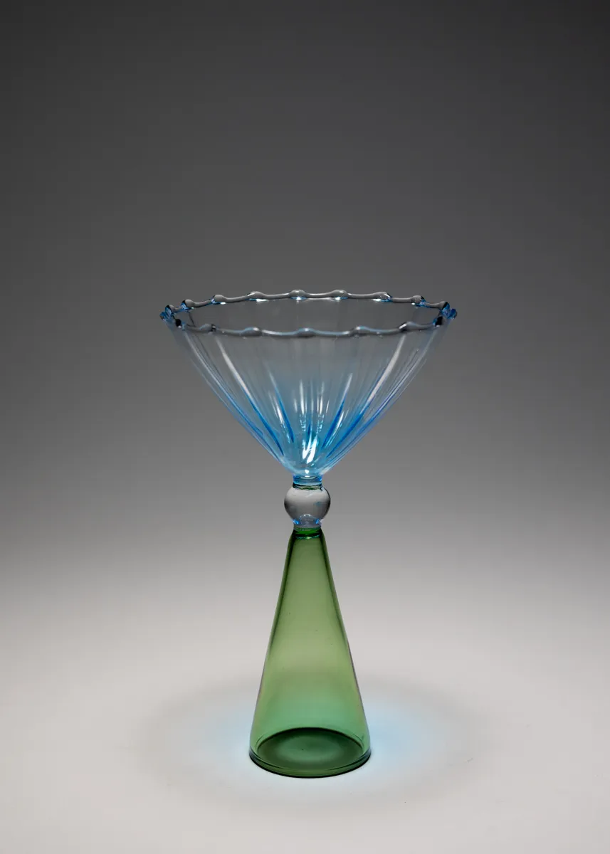 Medium Martini Glass with textured lines and blue tint radiating from the center the base or stem green and hollow