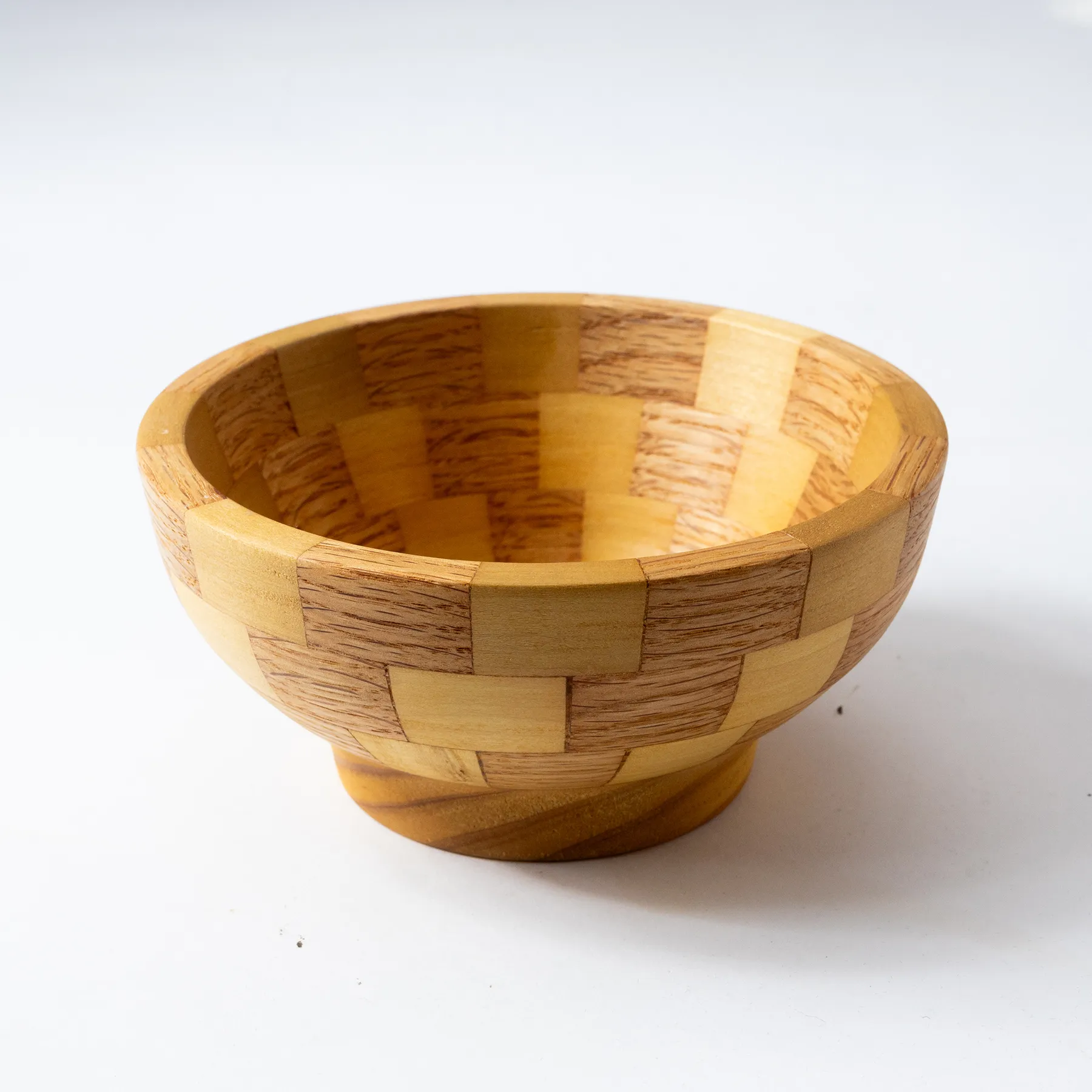 Small handmade wooden bowl with checkered pattern