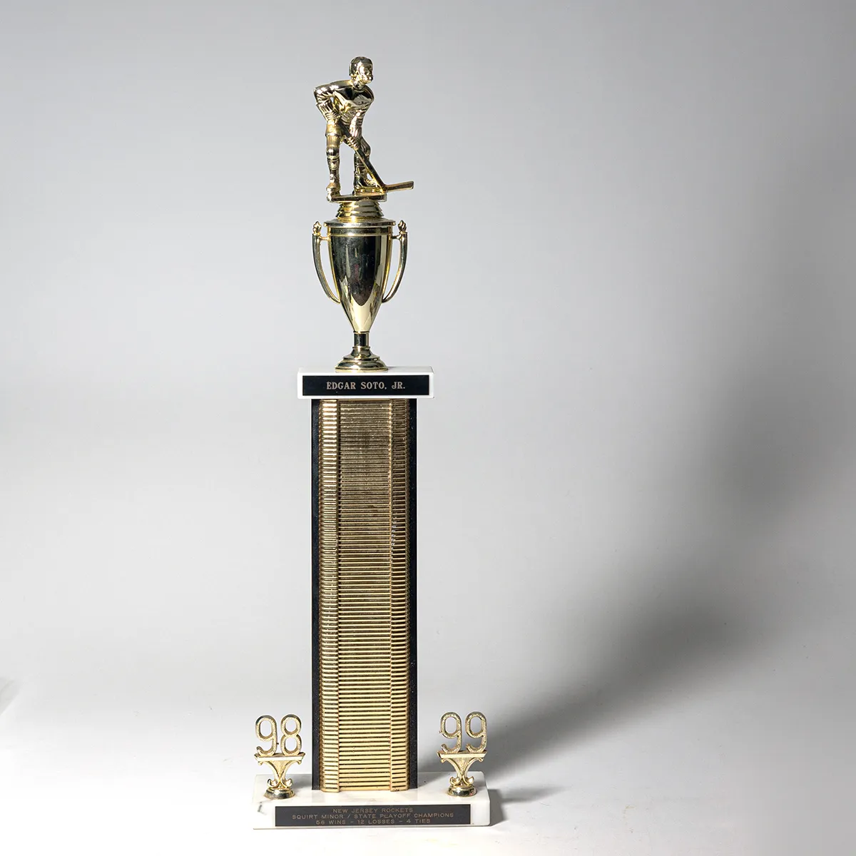 Tall Black and Gold Vintage Hockey Trophy with a player and a cup