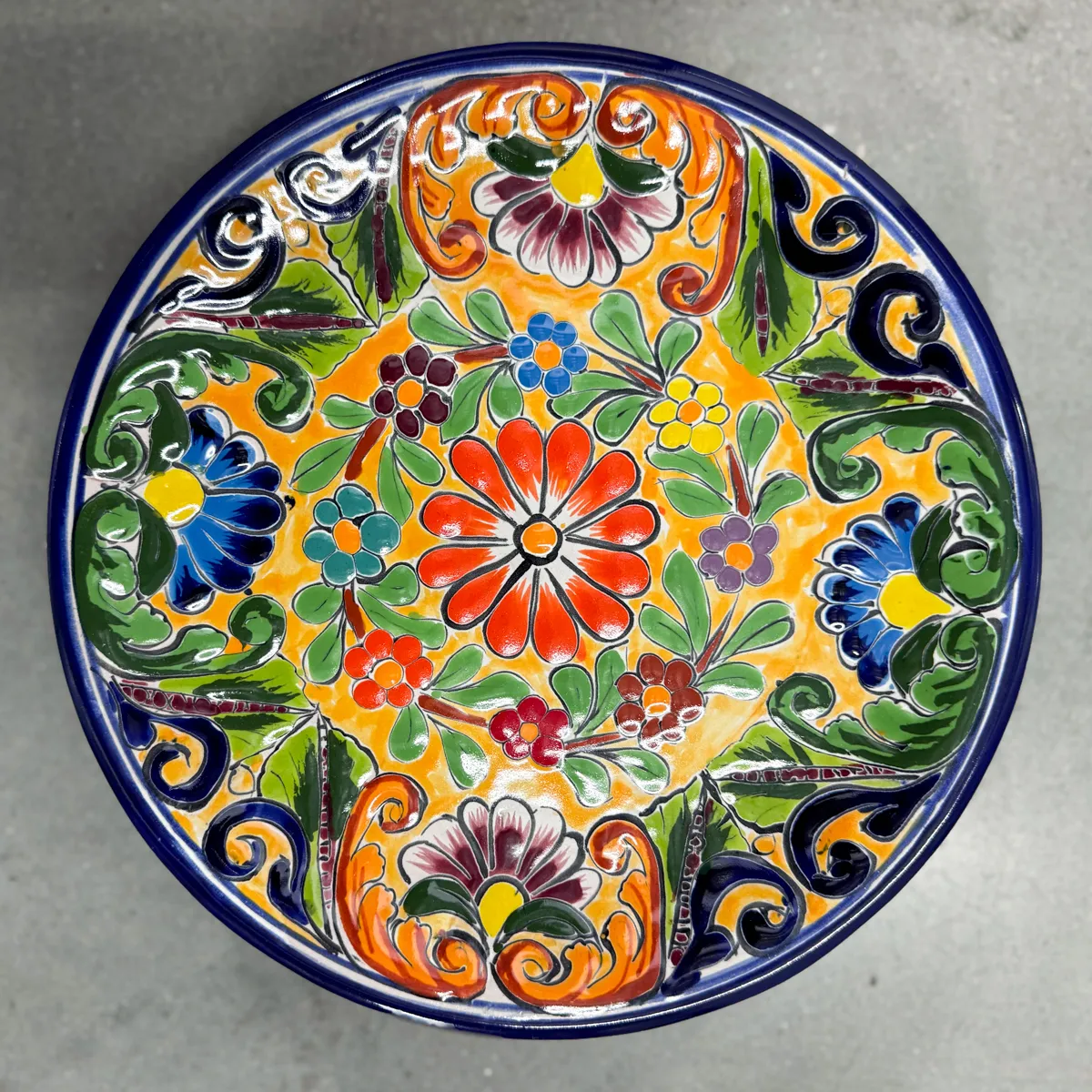 hand-painted Mexican Talavera pottery plate featuring vibrant floral designs
