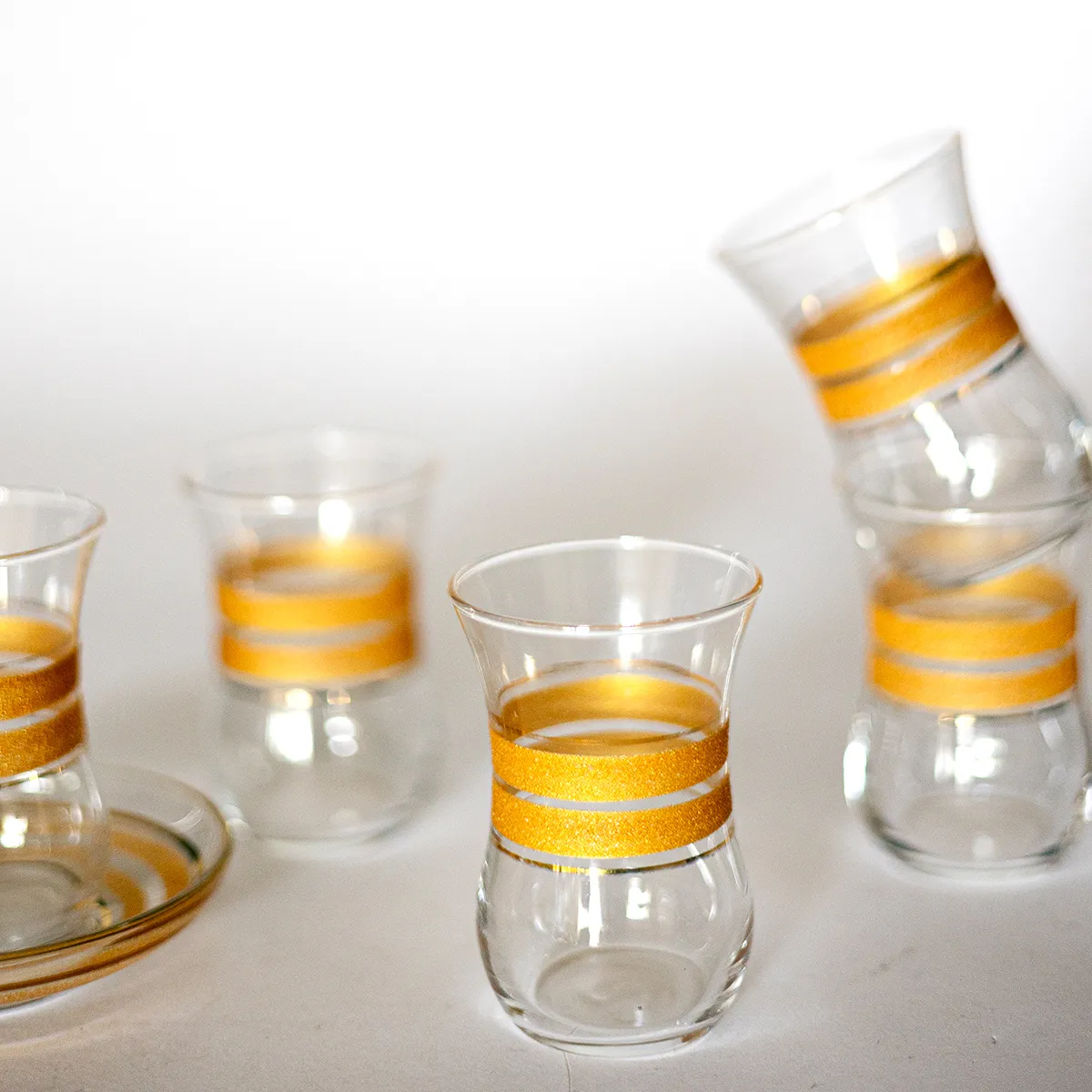 MCM Mid Century-Modern Hourglass shaped Shot Glasses with Matte Gold Around the Middle and Shiny Gold Flanking it. 