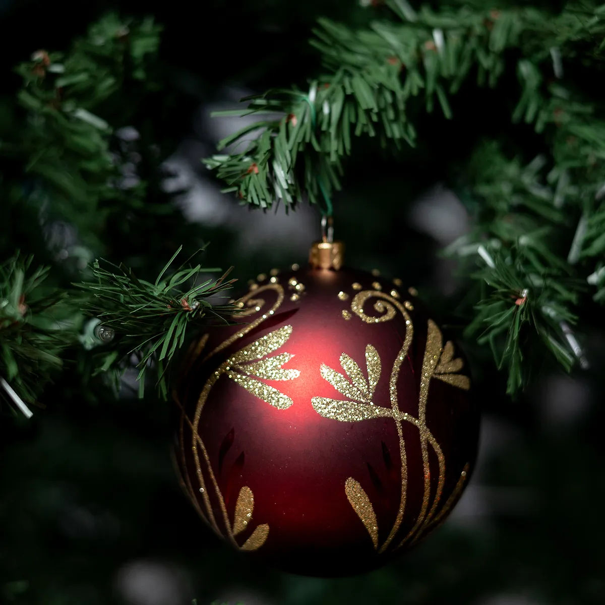 Maroon and Gold Sphere Christmas Tree Bulb. Gold Glitter looks like Abstract Flowers