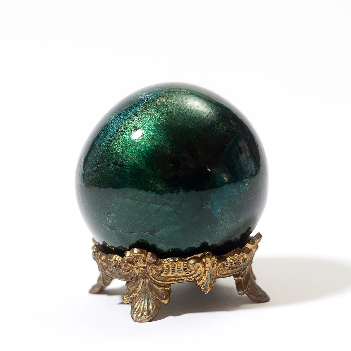 ceramic crystal ball, green resting in a brass footed stand - 4.5" x 4"
