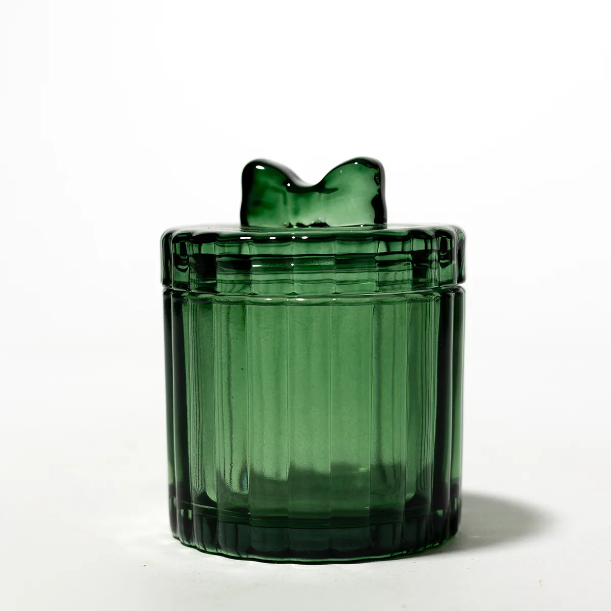 Round Cylinder ribbed green container  with a little green bow on the top for a handle