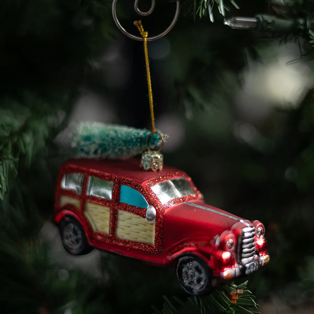 Vintage red station wagon with christmas tree on top Glass Christmas Ornament