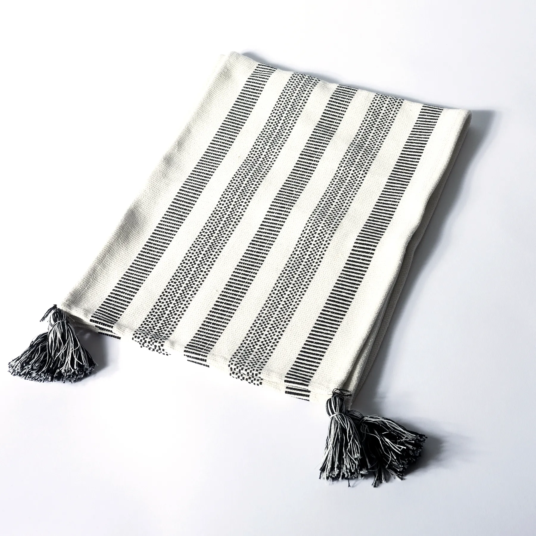 Black and White Woven table runner with tassels on the corners 13" x 27" 