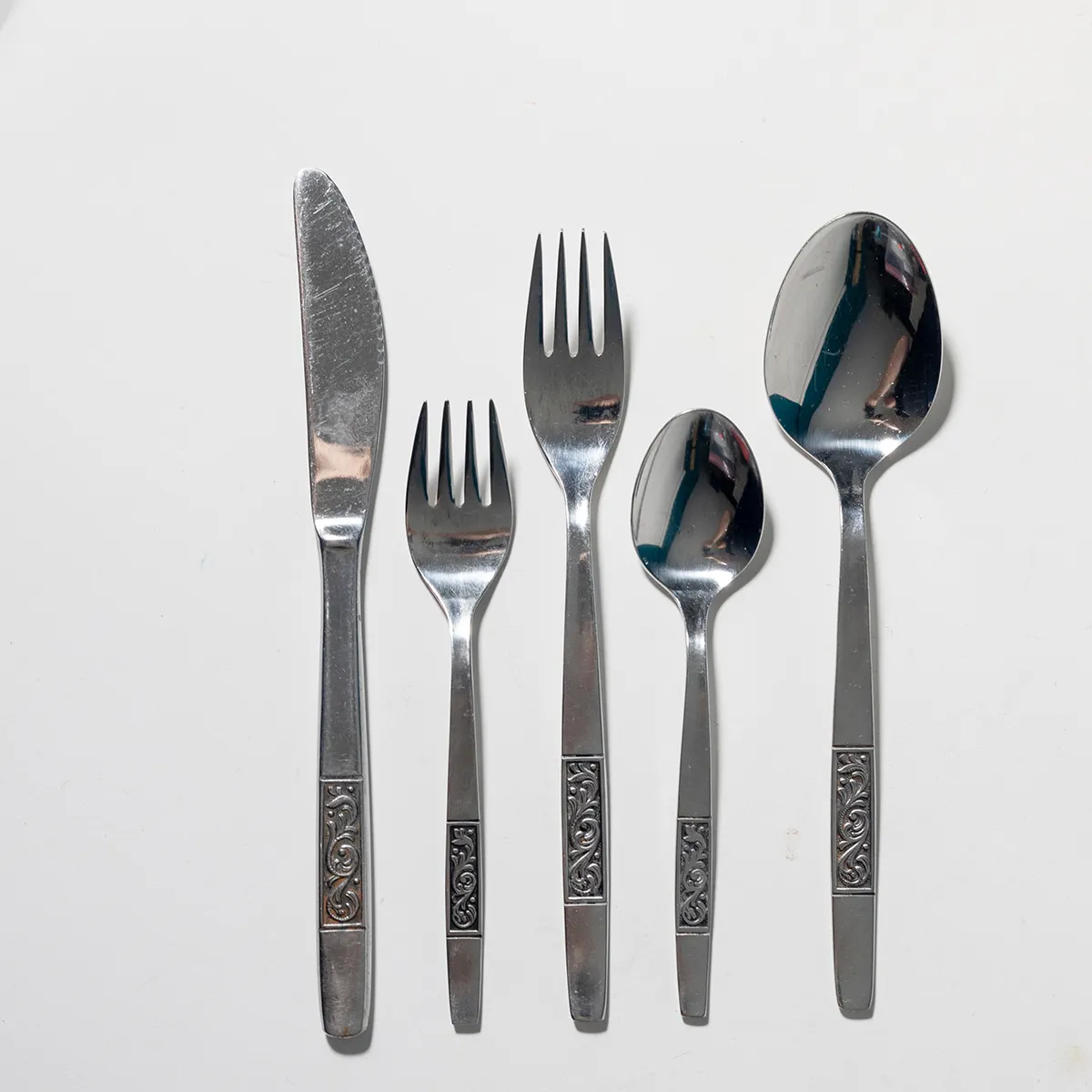 1970 Silverware with pressed design at the base, black and slicer, Salad and Dinner Fork, Butter Knife, Soup and regular Spoons 5 piece place setting priced per place setting