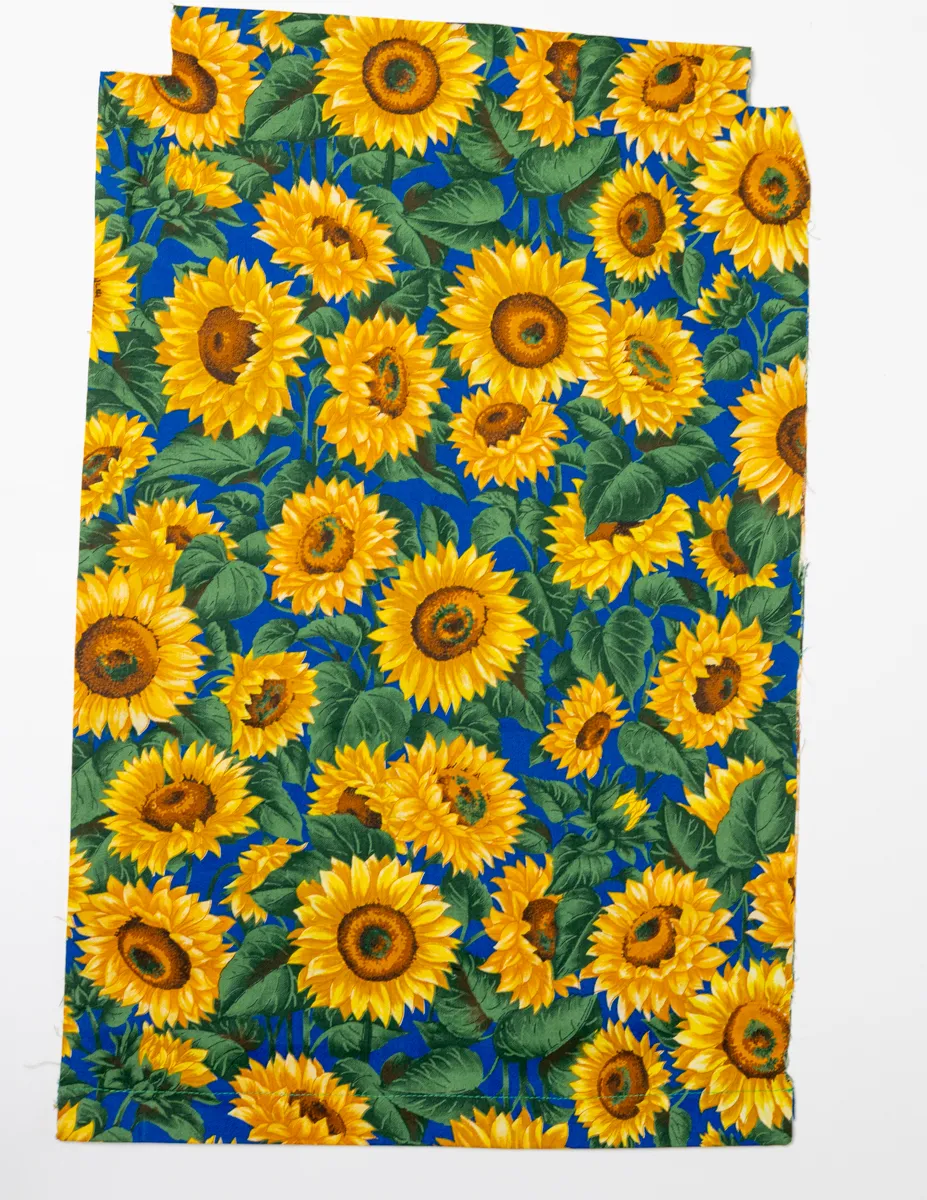 Bright Colorful Sunflowers with Greenery on a Electric Blue Background