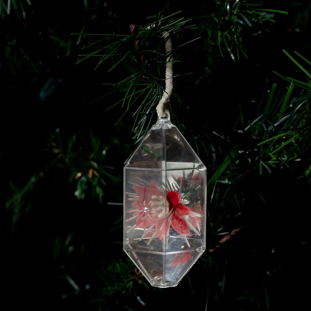 Christmas Tree Ornament: Clear and Silver Diorama with a tiny plastic poinsettia inside white pip cleaner hook