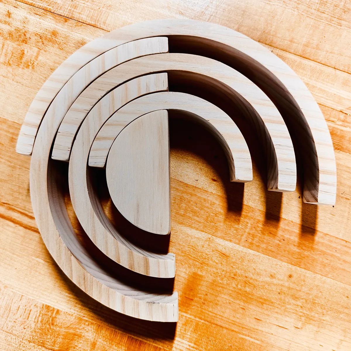 Arched nesting wooden risers