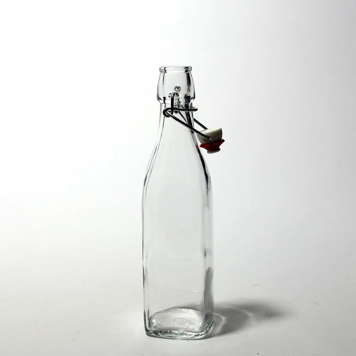 Square Shaped small clear bottle with a swing stopper