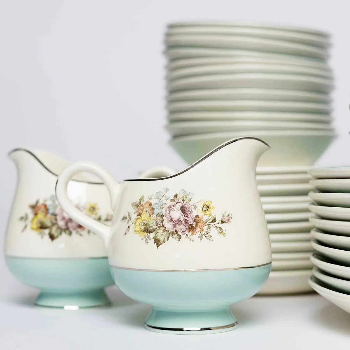 Dining Fine China: Cream Pitcher - Sketched Pink, Yellow and Green Flower Pattern in the middle on off White with a wide Tiffany Blue Robins Eggs Blue Band around the outside