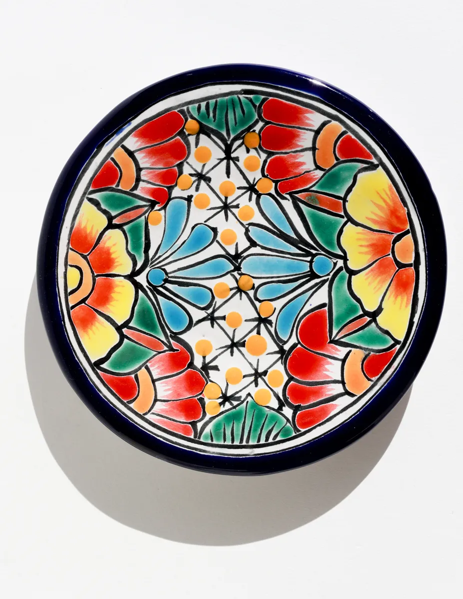 hand-painted Mexican Talavera pottery plate featuring vibrant floral designs