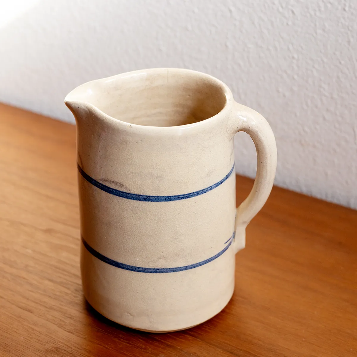 Vintage Ceramic Water Pitcher Cream Colored with two blue lines running around it