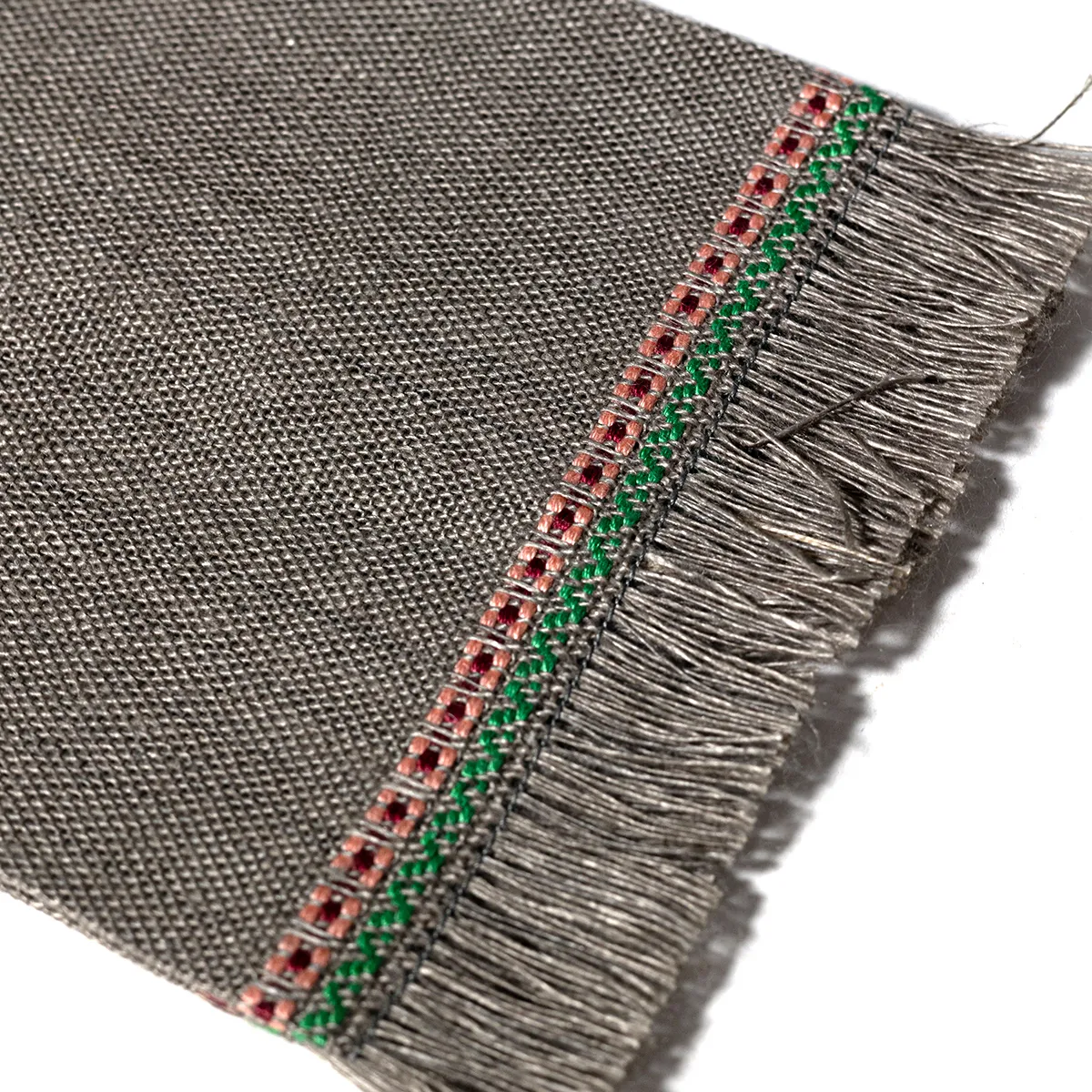 Gray Woven Placemat with a Border of pink and green plus Fringe
