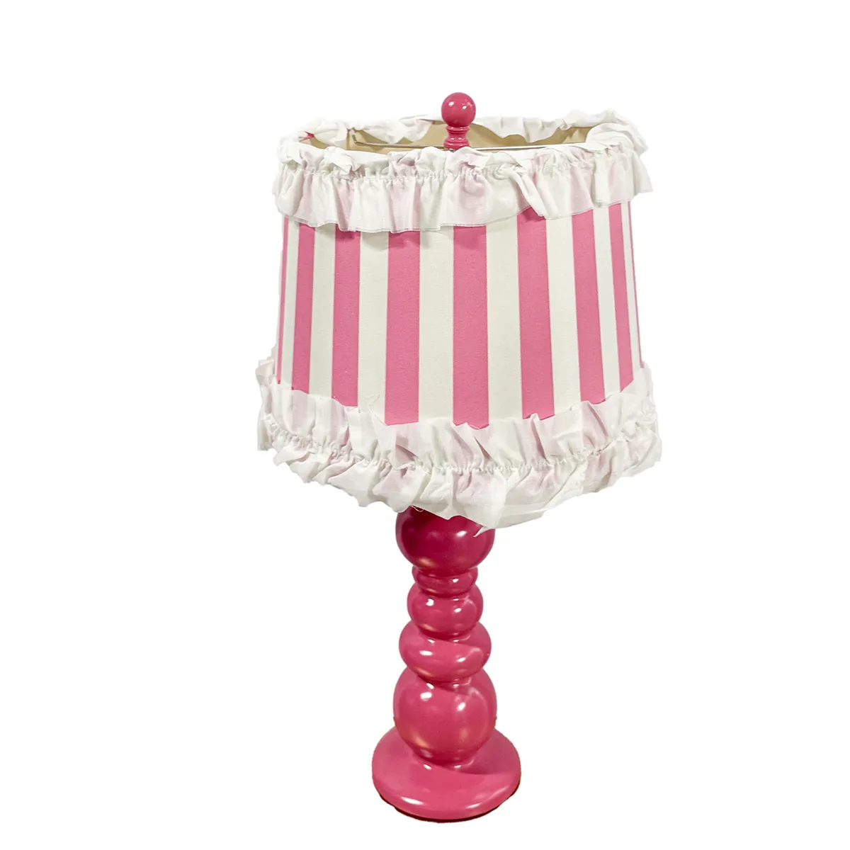 Bold Pink Ceramic Stacked ball lamp with vertical pink striped lampshade with ruffleson the top and bottom