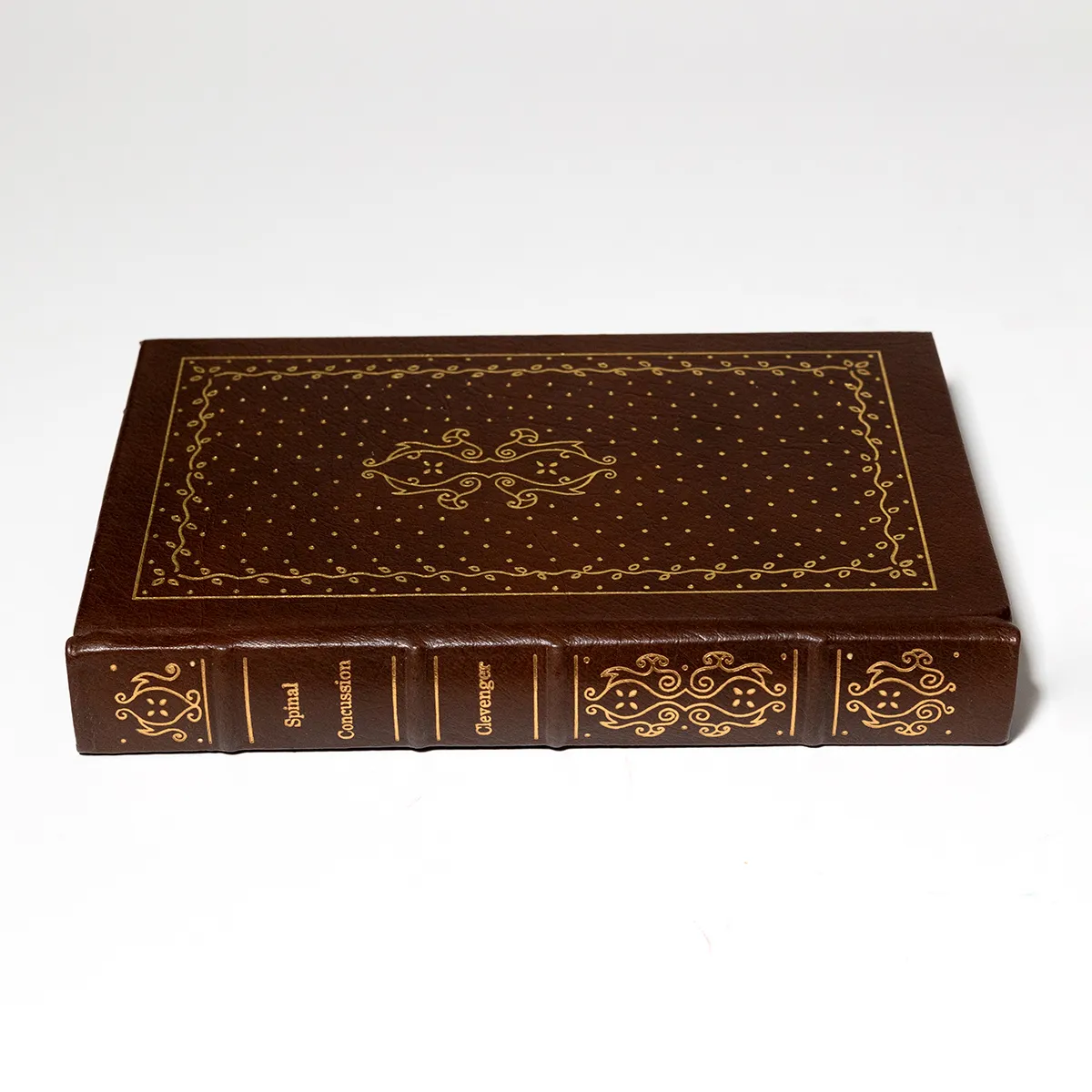 Book: Medical Book Surgical Spinal Concussion. Brown Quarter leather with hubbed spine and gilt gold lettering/decoration. Gilded page edges. Silk page marker ribbon