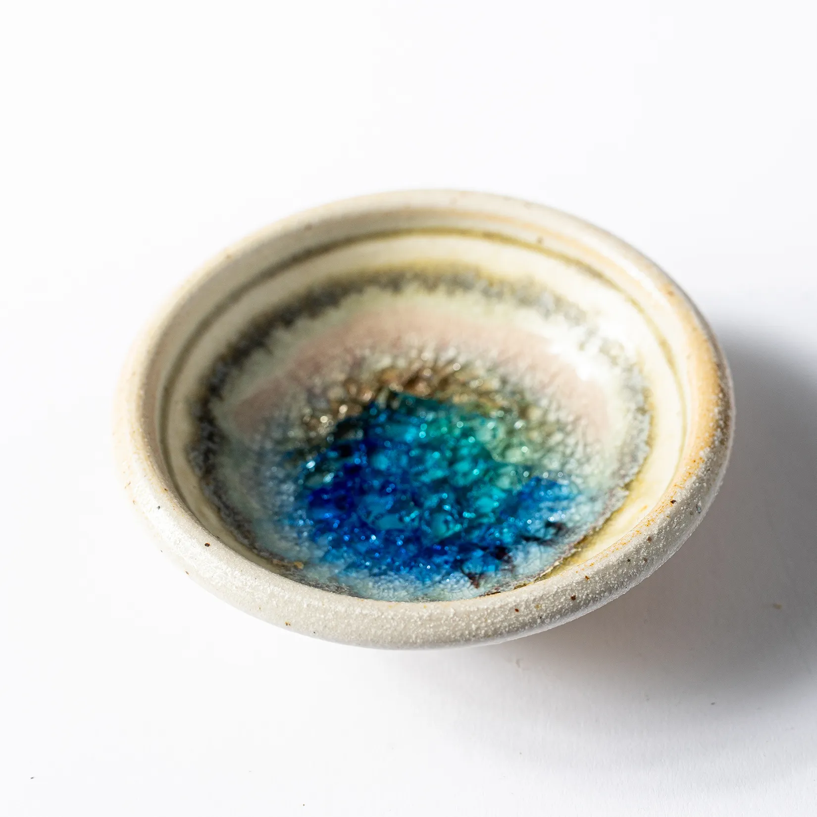 Cream Pottery pinch bowl blue glass - 1.25" x 3.75"