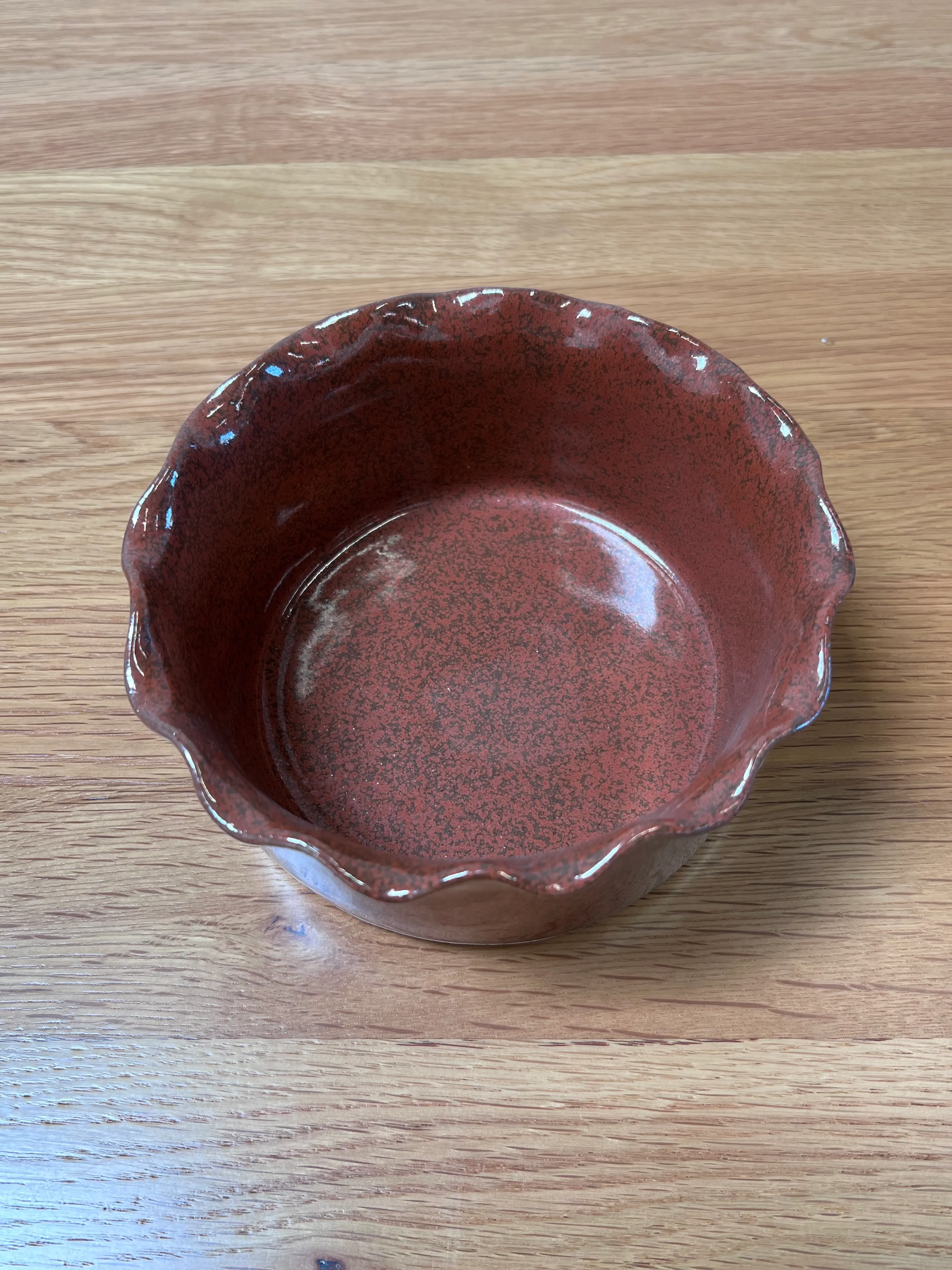 Small red bowl with scalloped rim