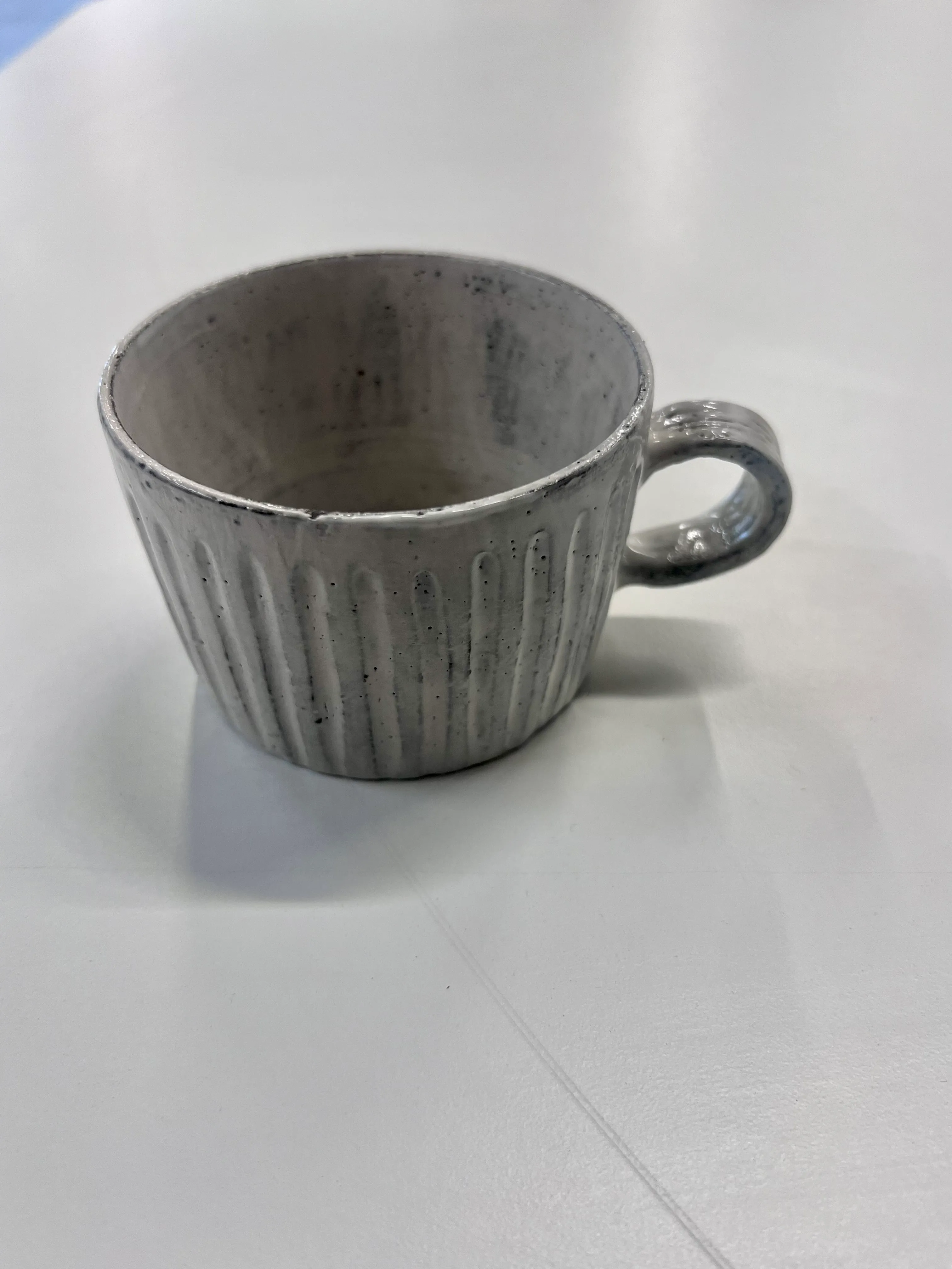 Handmade grey short mug, faceted 