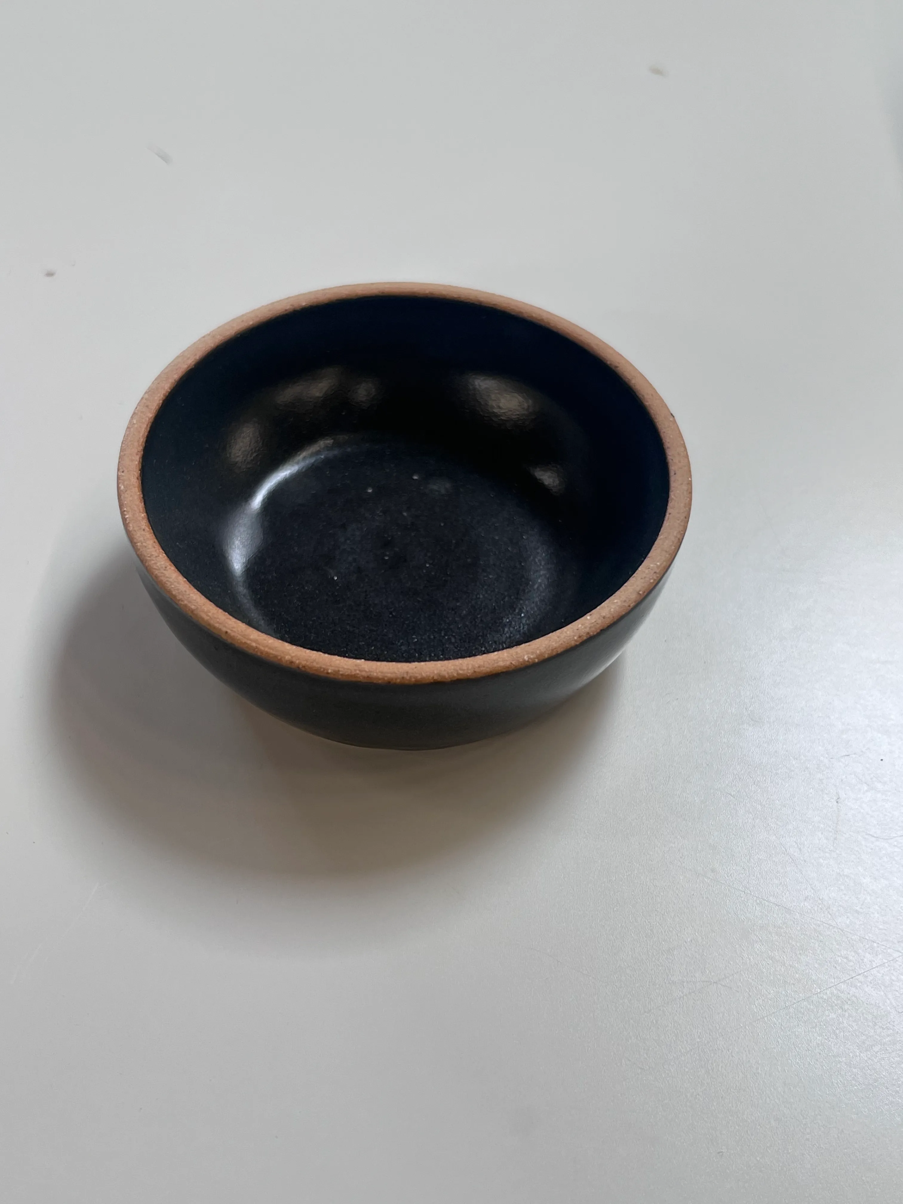 Black salt dish with unglazed rim