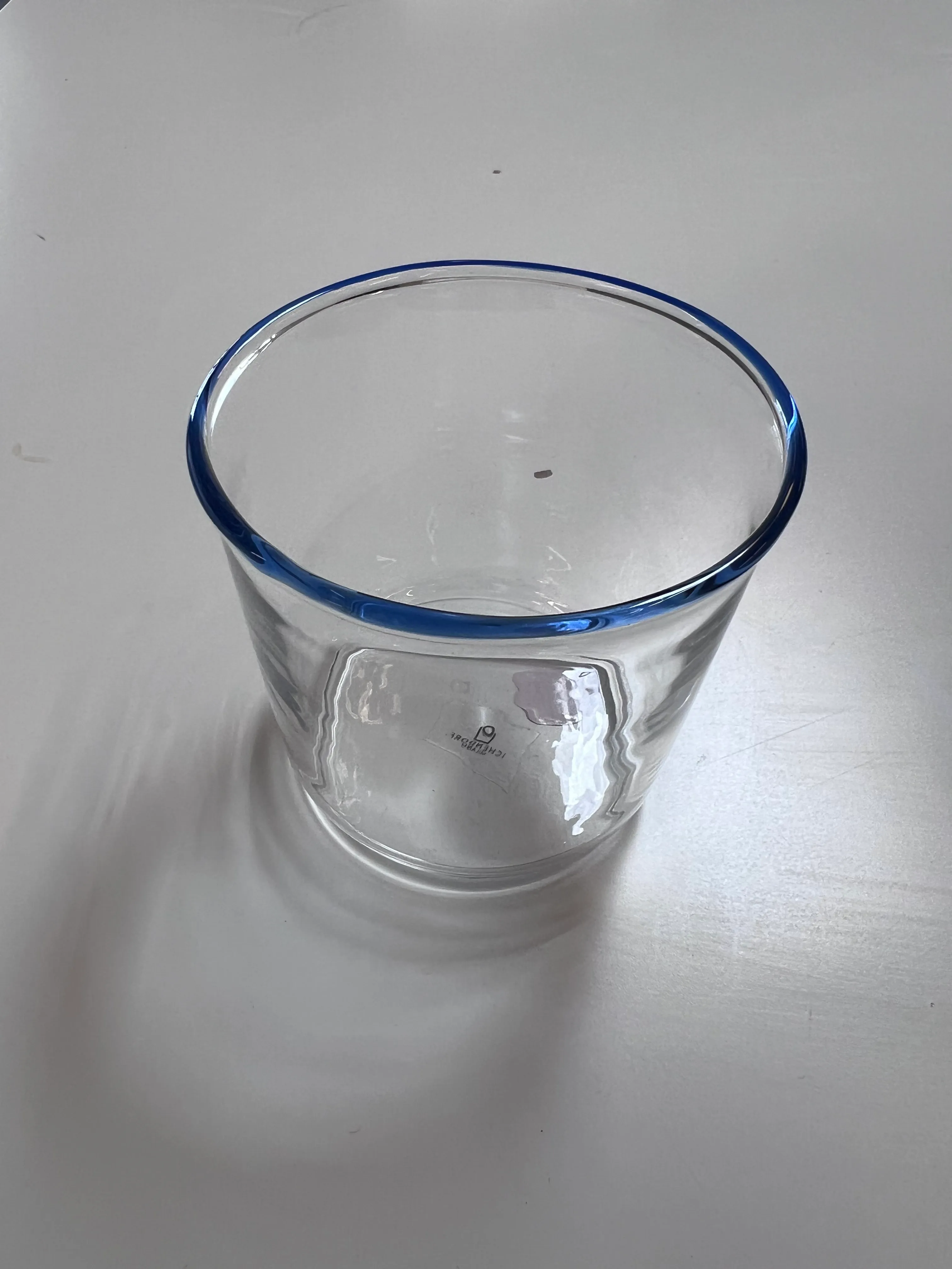 Clear tumbler with blue rim