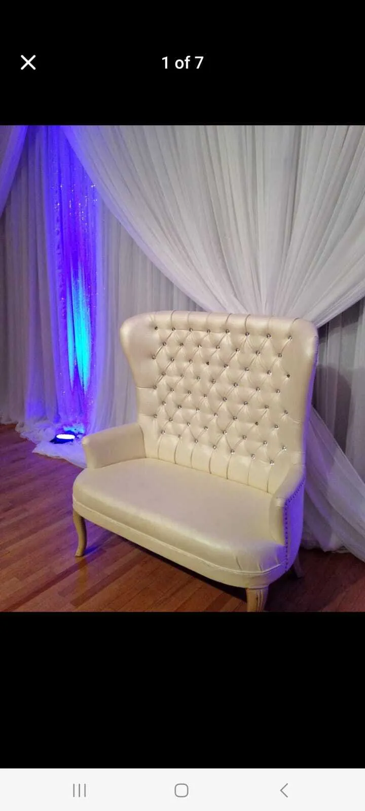 high-back white faux-leather wedding loveseat featuring crystal tufted button detailing and curved wooden legs