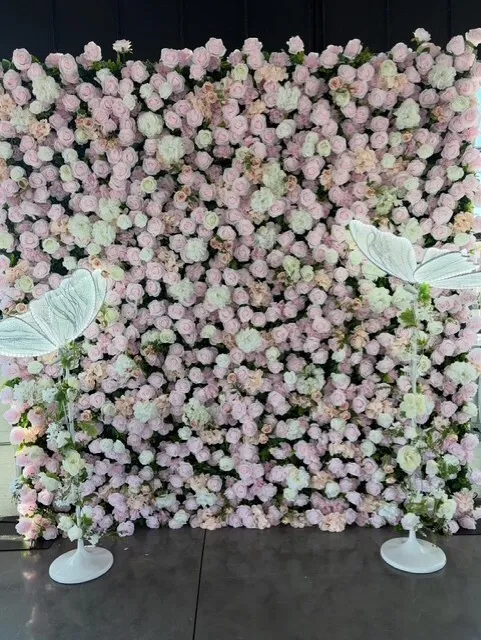 Pink flower wall backdrop with decorative butterfly lamps at graduation celebration at The Delaware Wedding & Event Space