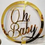 gold color "oh baby" sign