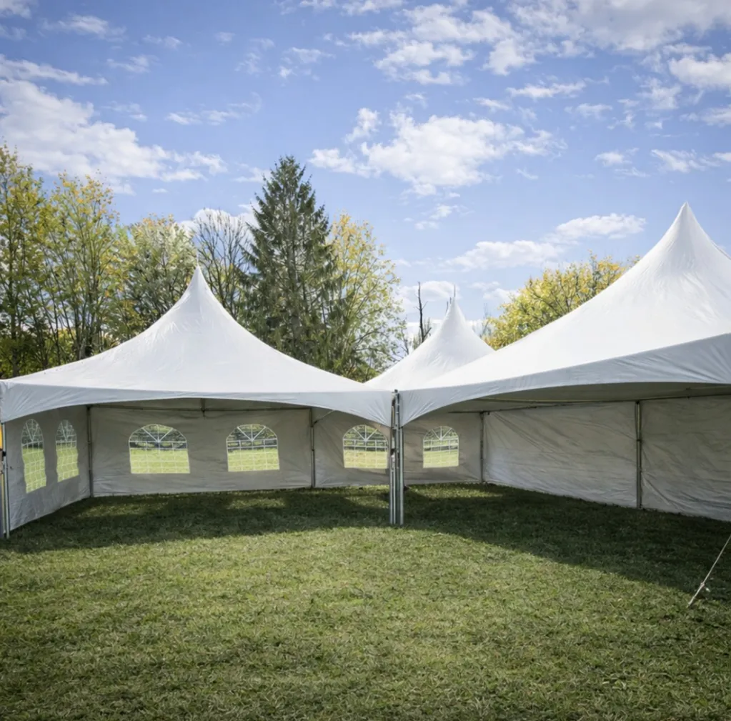 High-Peak Marquee Tent Package – 1,200 Sq Ft (Includes Tent, Tables & Seating for 144 Guests) Sidewalls, dance floor, lighting, and décor available for an additional fee and can be added during booking.