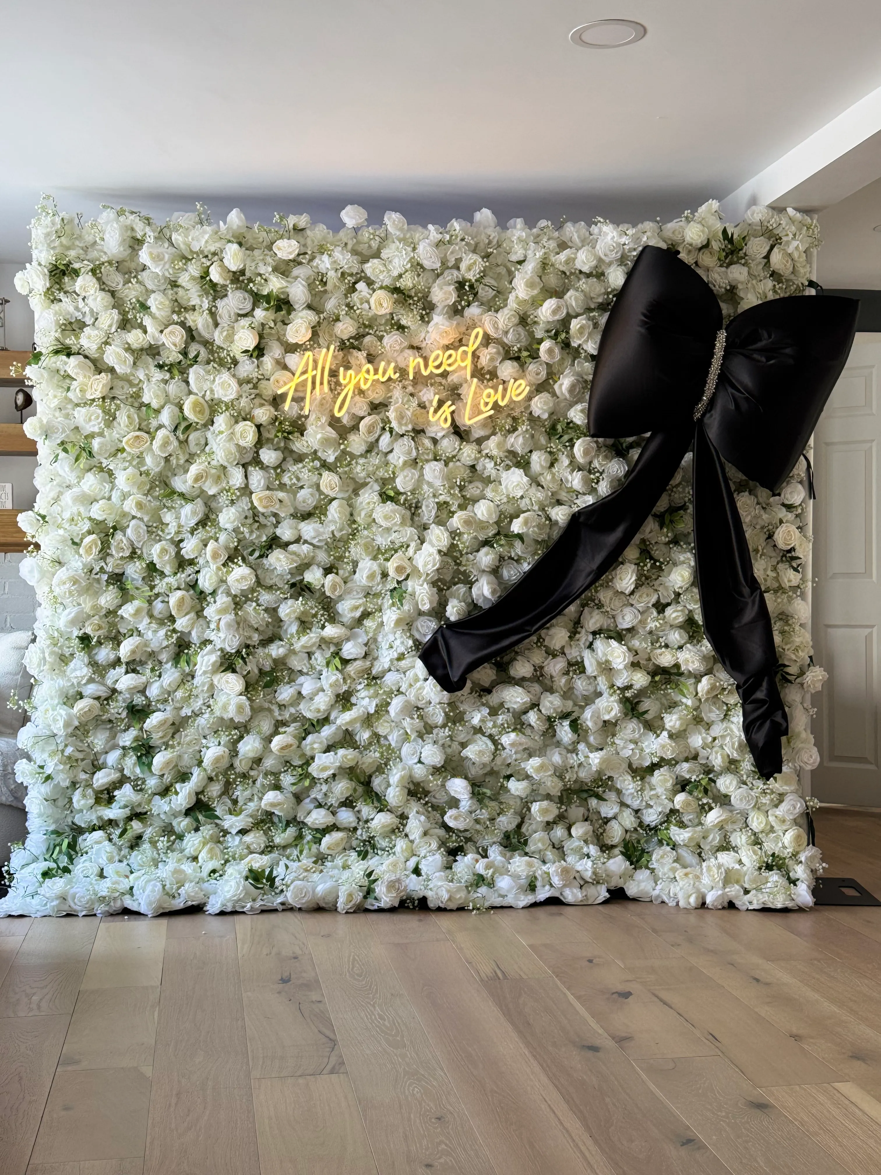 White Flower Wall with Black Bow