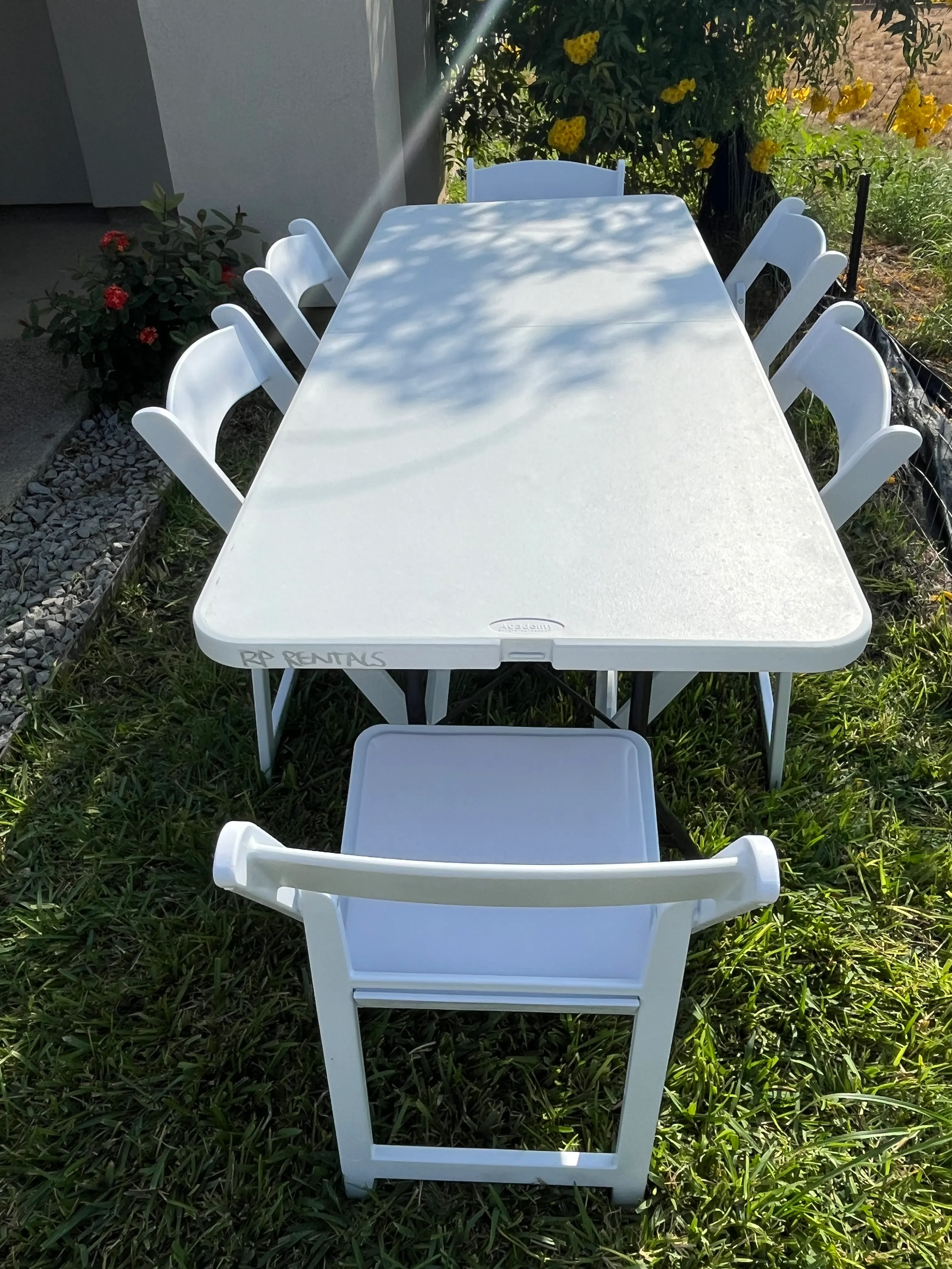 6 ft table and 6 white resin chairs