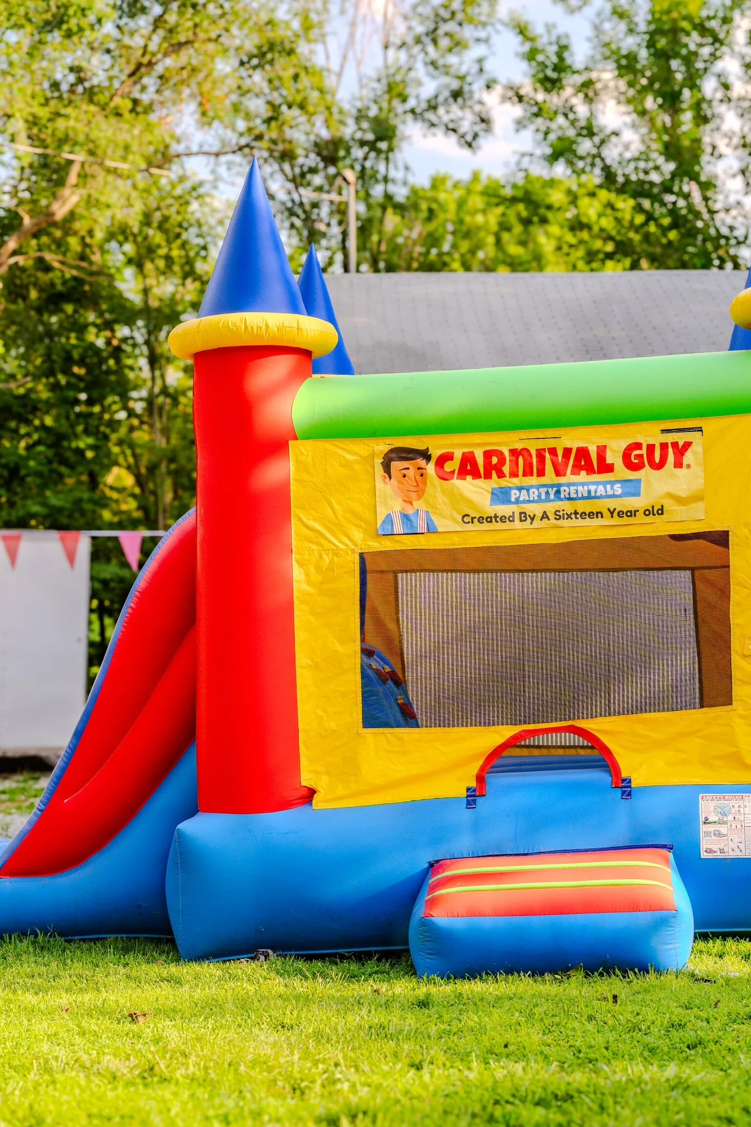 Colorful bounce house set up at an outdoor birthday party in Northeast Kansas with children enjoying the inflatable.