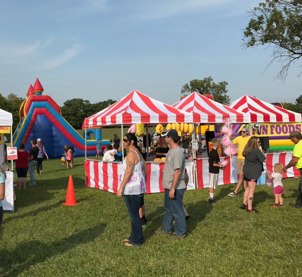 Large scale corporate festival planned by Carnival Guy Party Rentals featuring massive inflatables, staging, and outdoor company picnic catering.