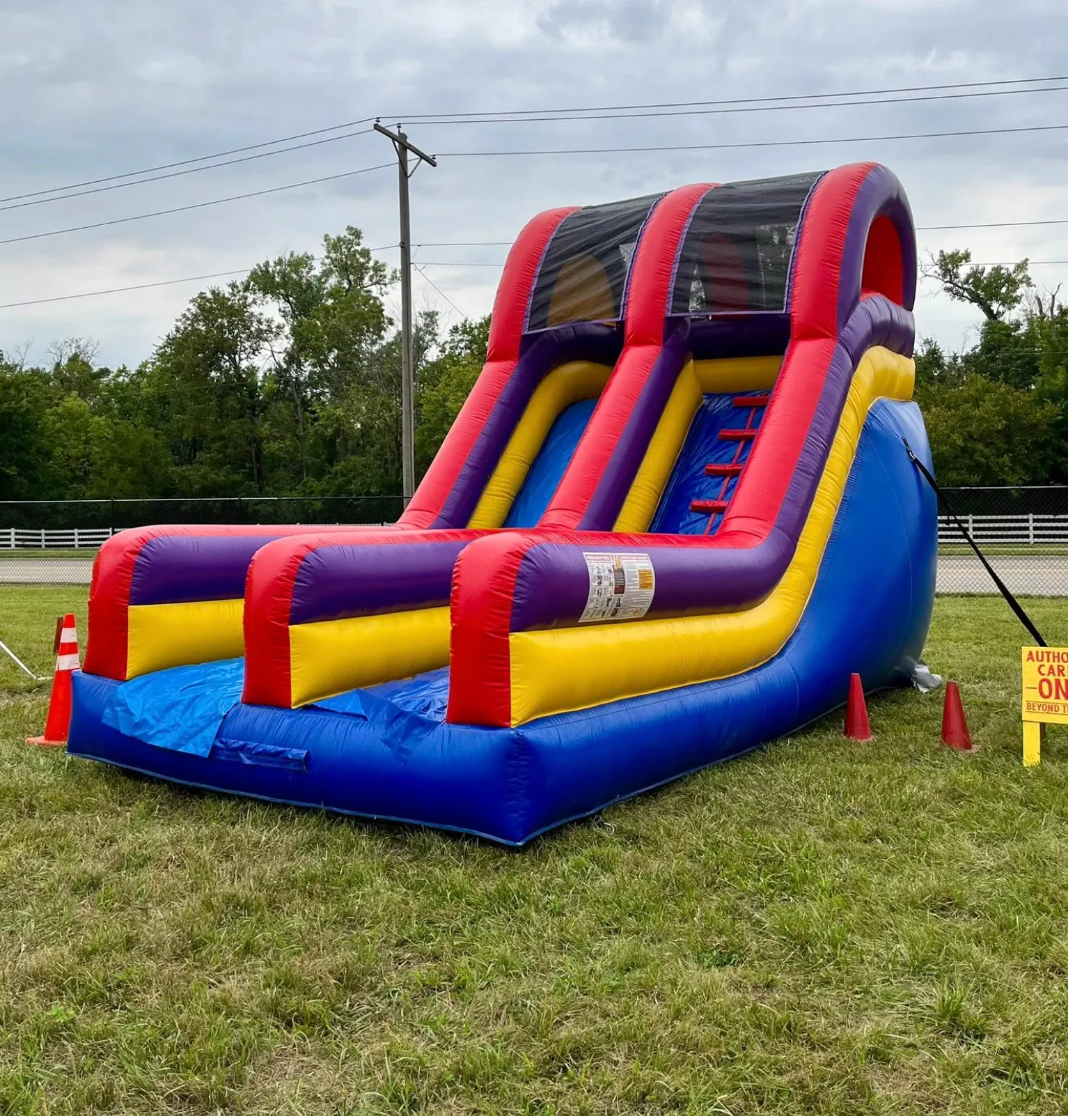 Large inflatable water slide setup for a summer festival in Northeast Kansas by Carnival Guy.
