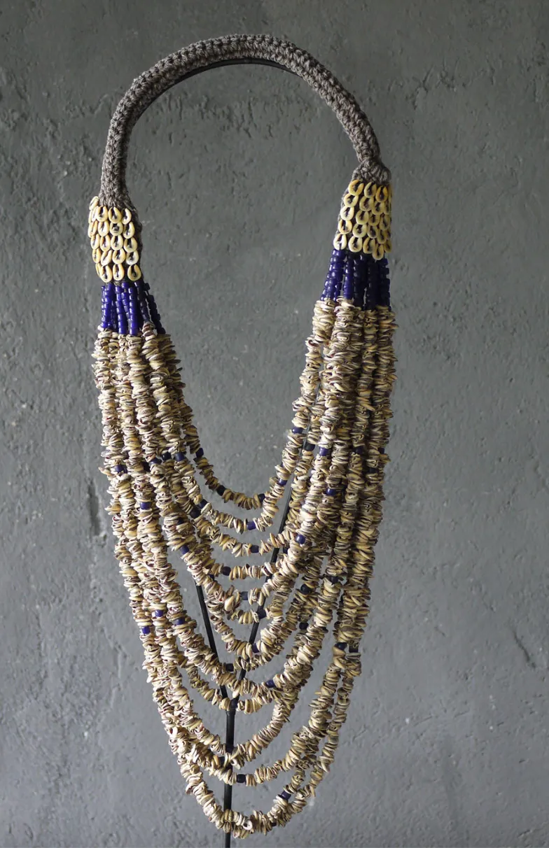 bead and shell necklace on stand  27"h