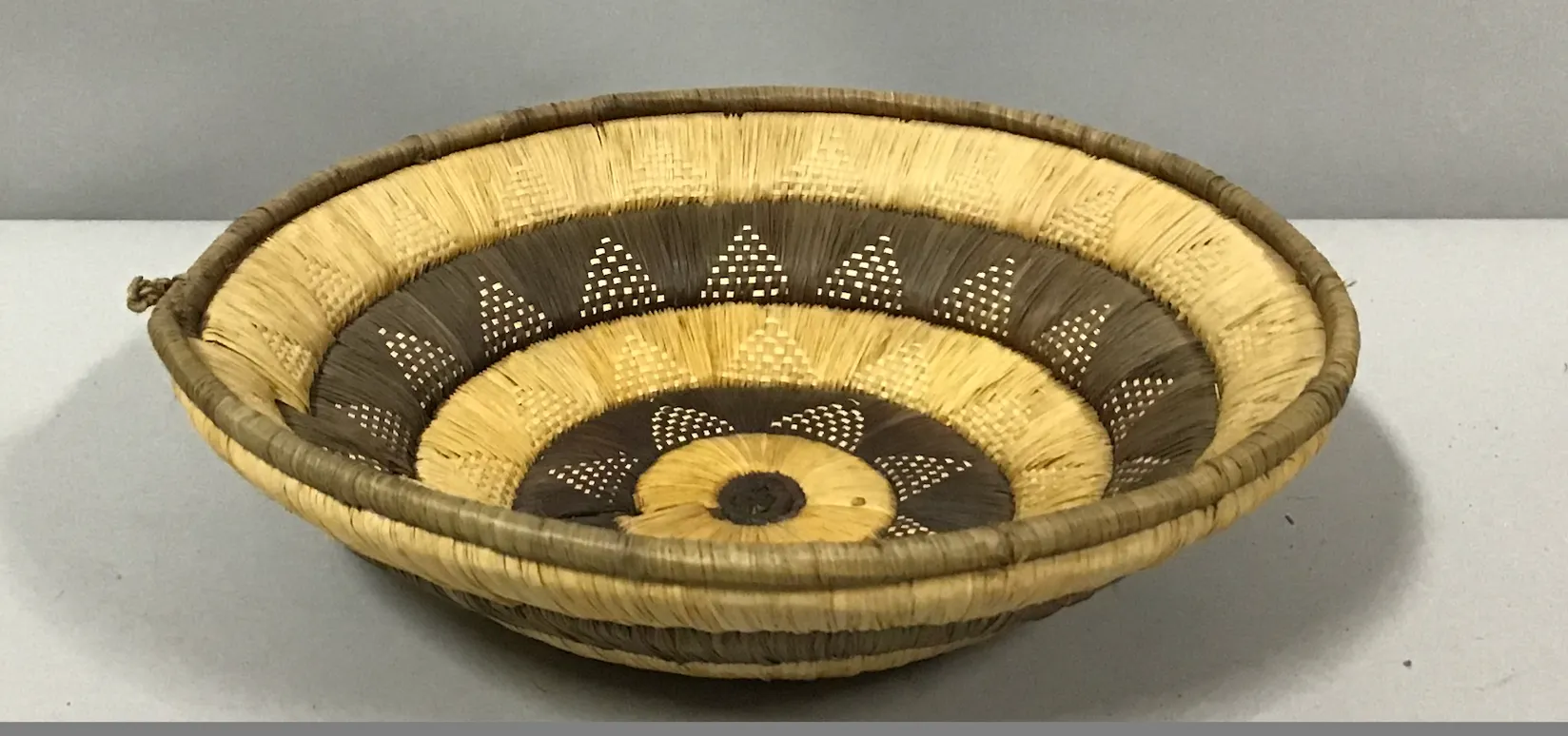 flat brown and natural african woven bowl basket  11"dia x3"deep