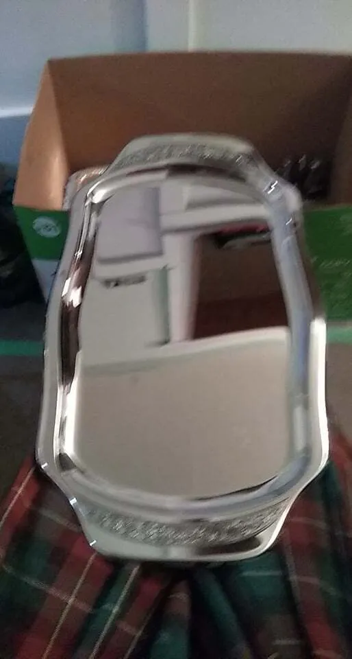 Rectangular stainless steel serving platter with embossed handles and mirrored surface