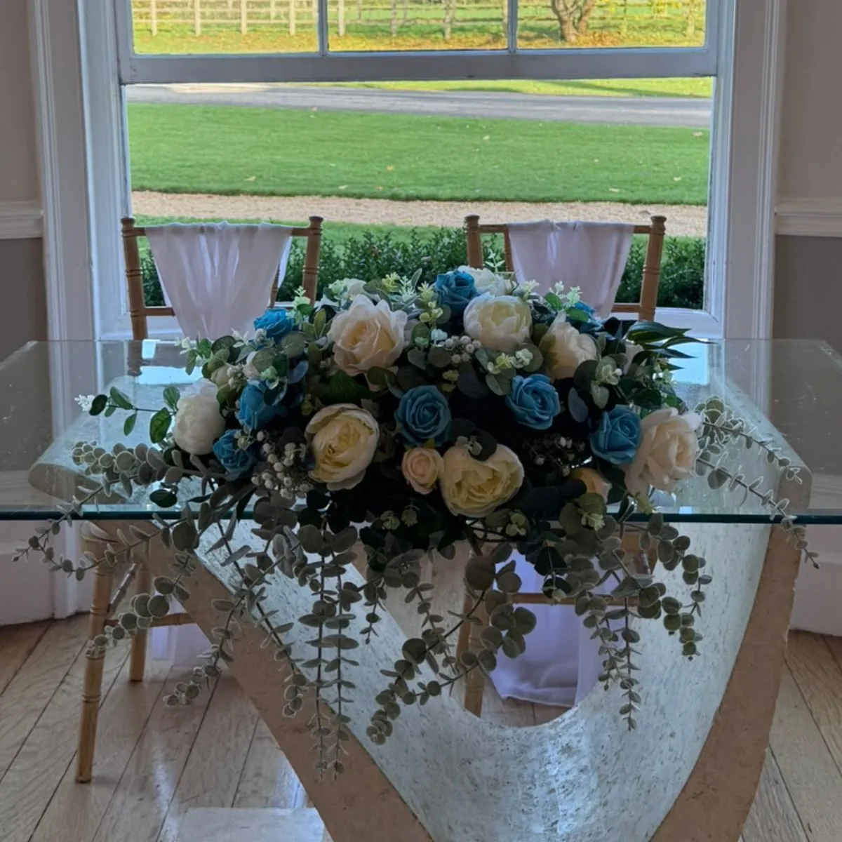 Turquoise Blue & White Low And Long Flower Arrangement For Hire